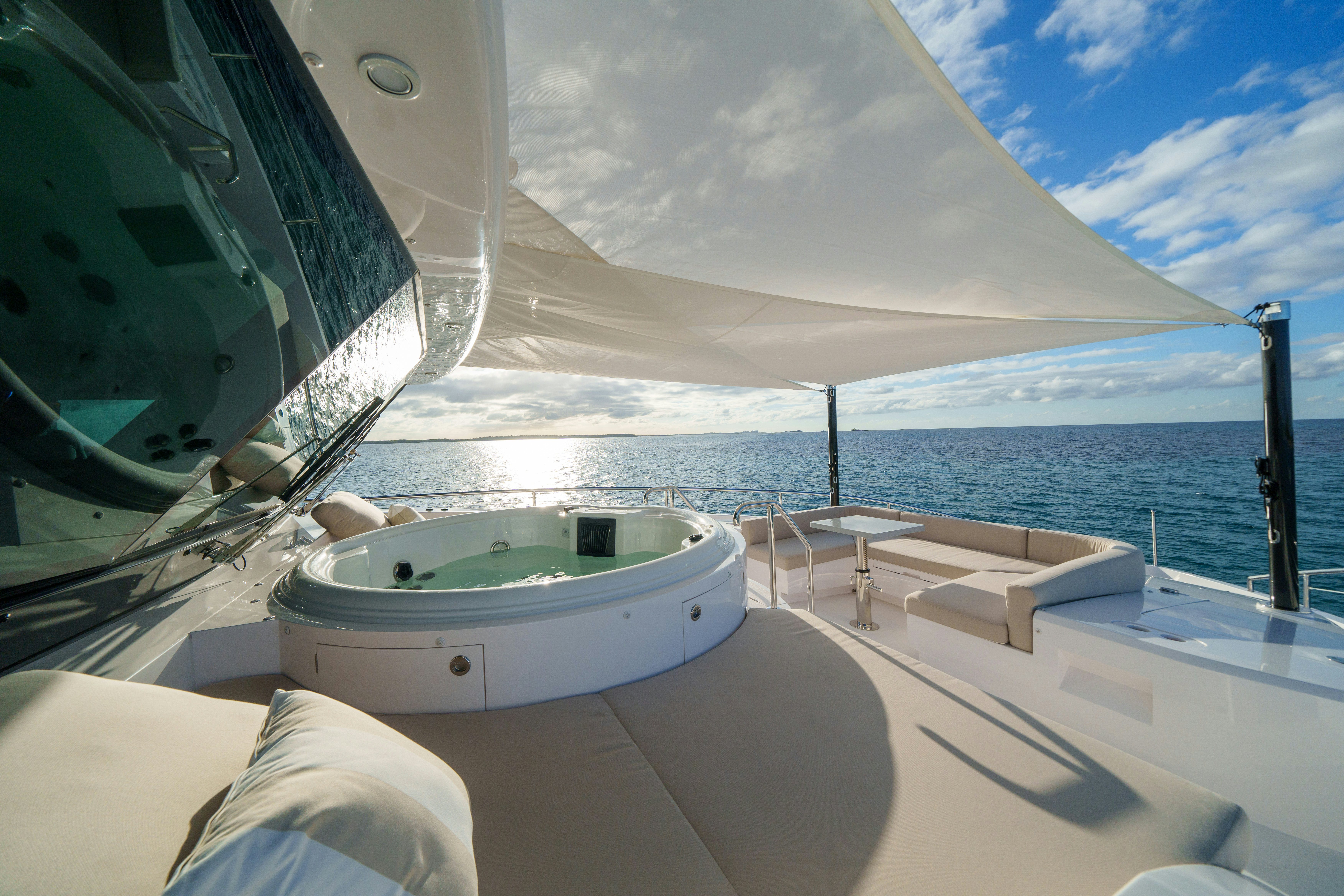 a bathtub in a room with a large window overlooking a body of water aboard RIO Yacht for Sale
