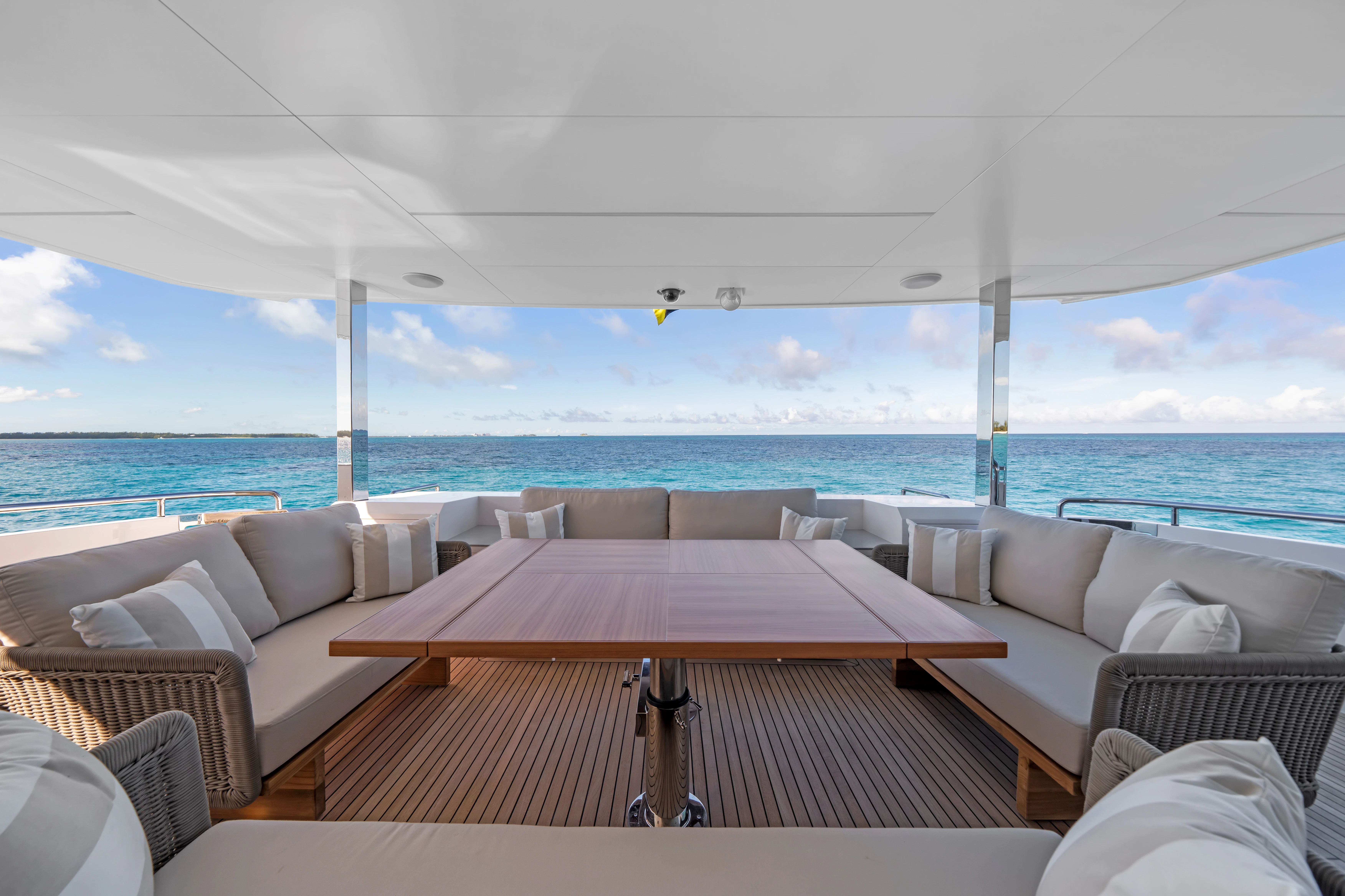a room with a table and chairs on it by the ocean aboard RIO Yacht for Sale