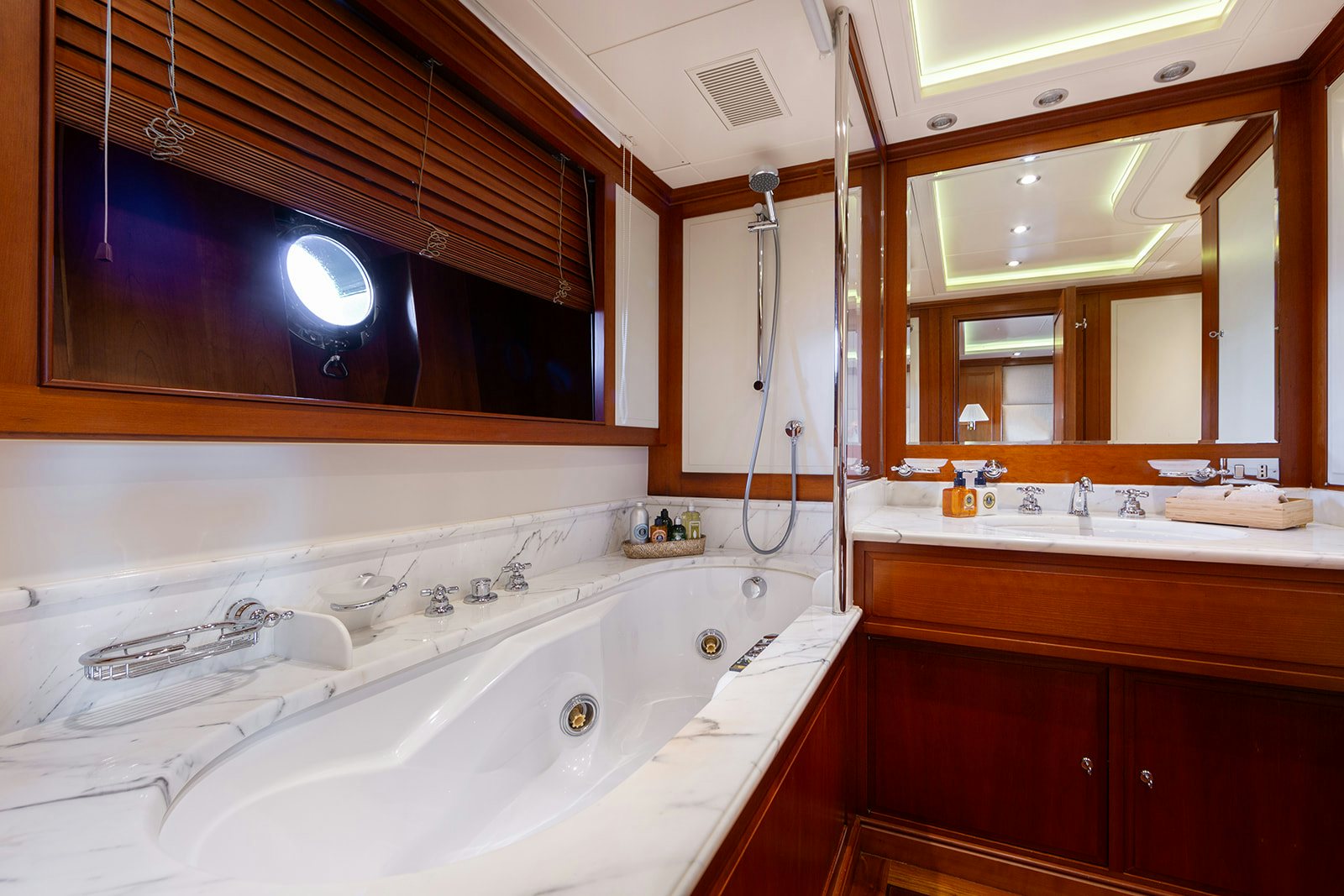 a bathroom with a tub sink and a mirror aboard NORFOLK STAR Yacht for Sale