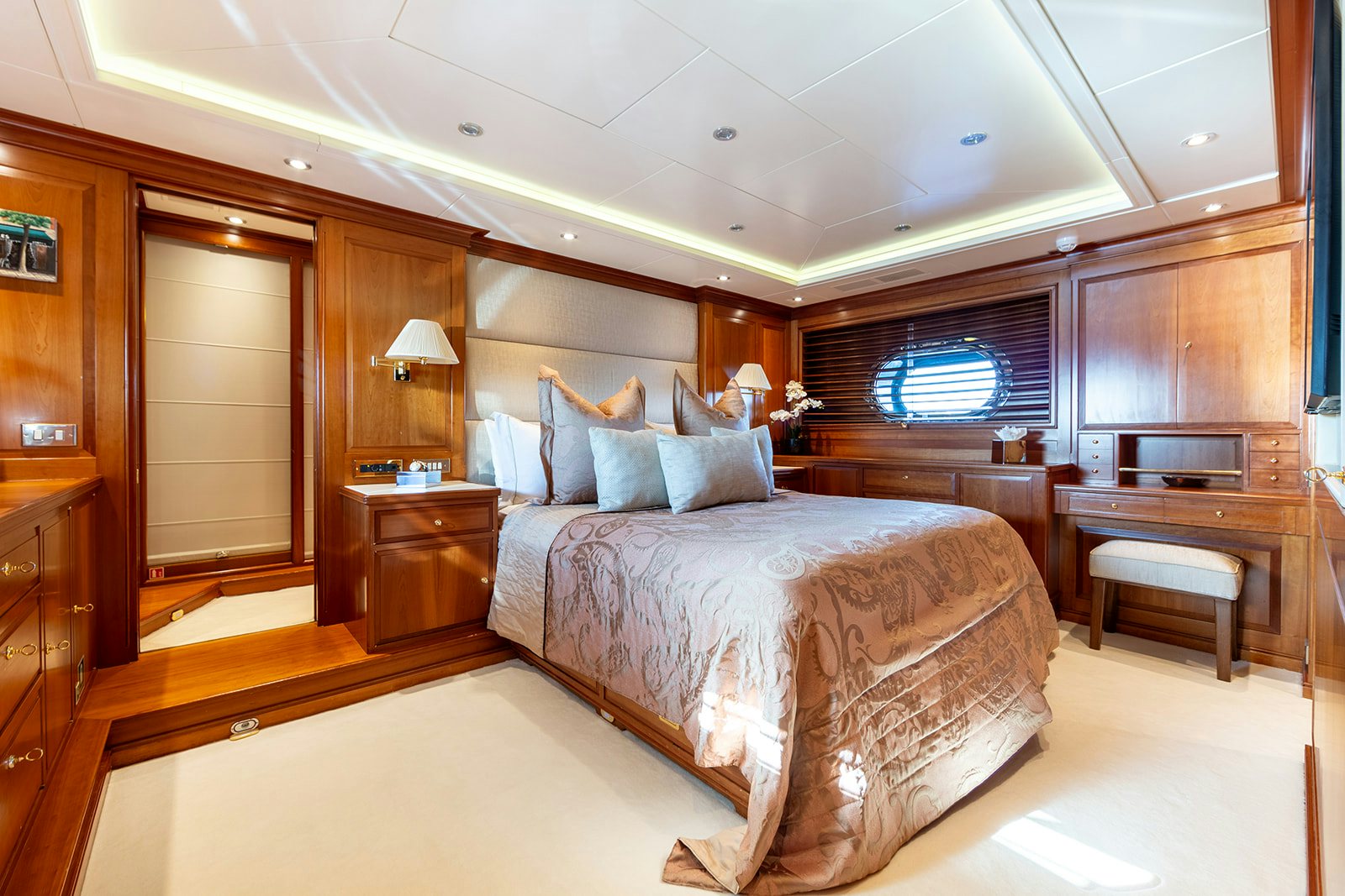 a bedroom with a bed and a desk aboard NORFOLK STAR Yacht for Sale