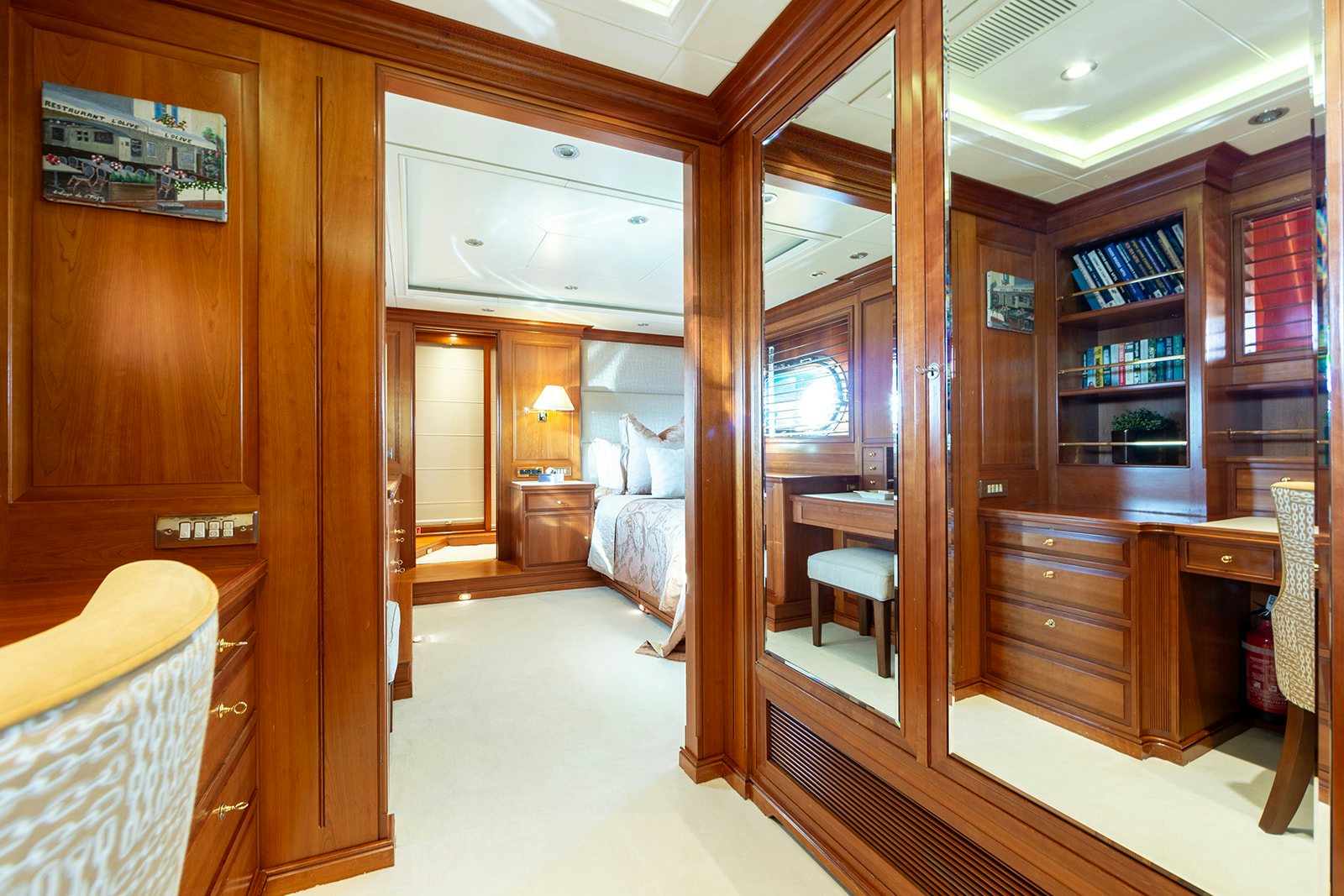 a room with a bed and a bookcase aboard NORFOLK STAR Yacht for Sale