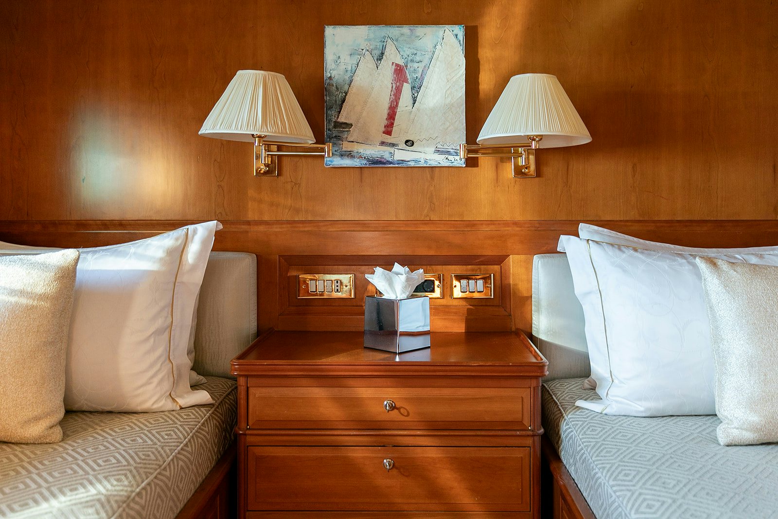 a bed with a lamp and a book on it aboard NORFOLK STAR Yacht for Sale