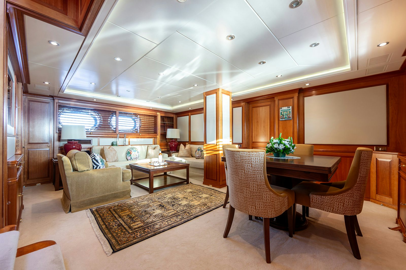 a living room with a couch and a table aboard NORFOLK STAR Yacht for Sale