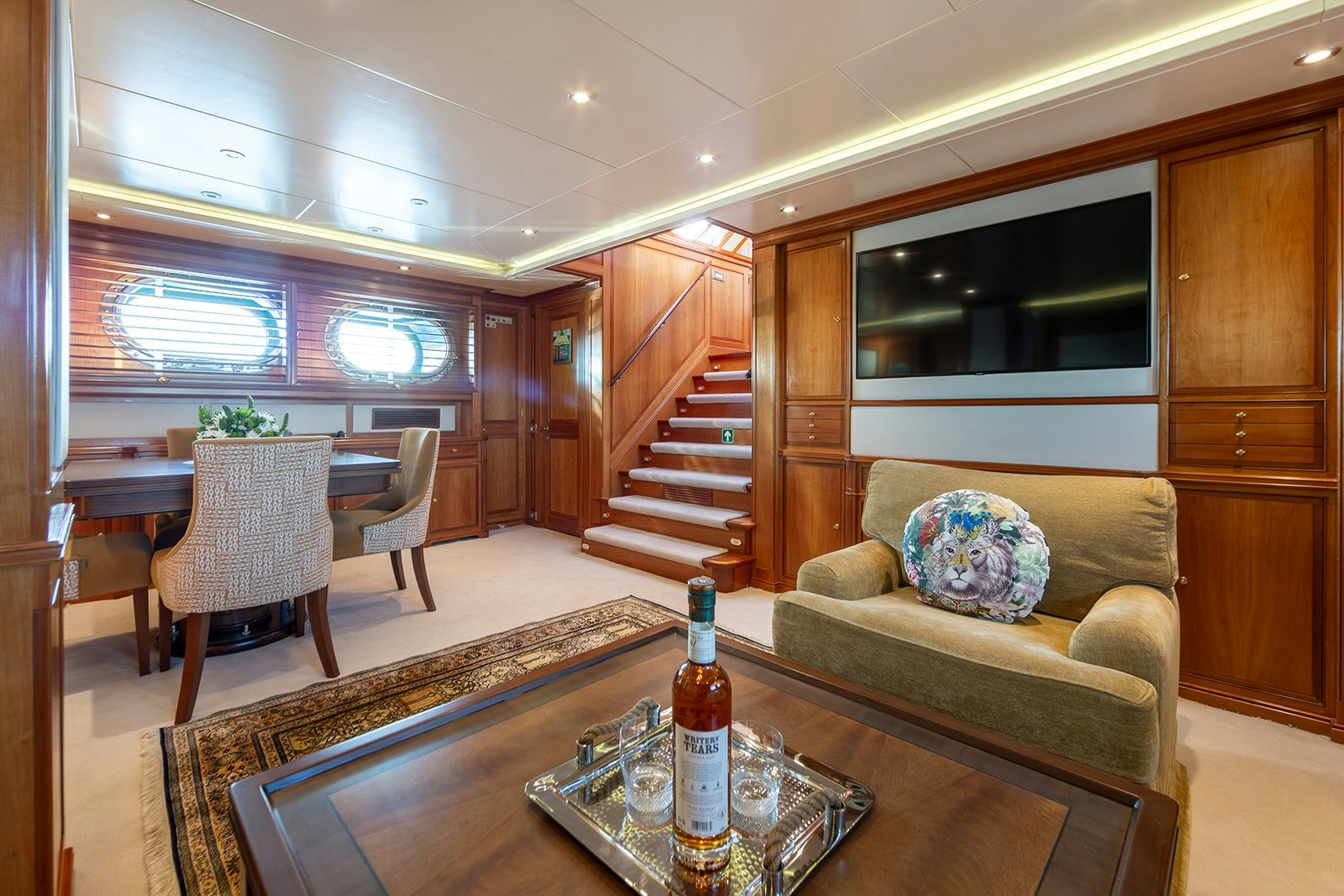 a living room with a couch and a table aboard NORFOLK STAR Yacht for Sale