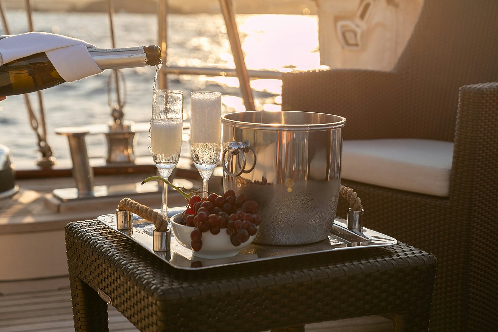 a table with a glass and a bowl of grapes on it aboard NORFOLK STAR Yacht for Sale