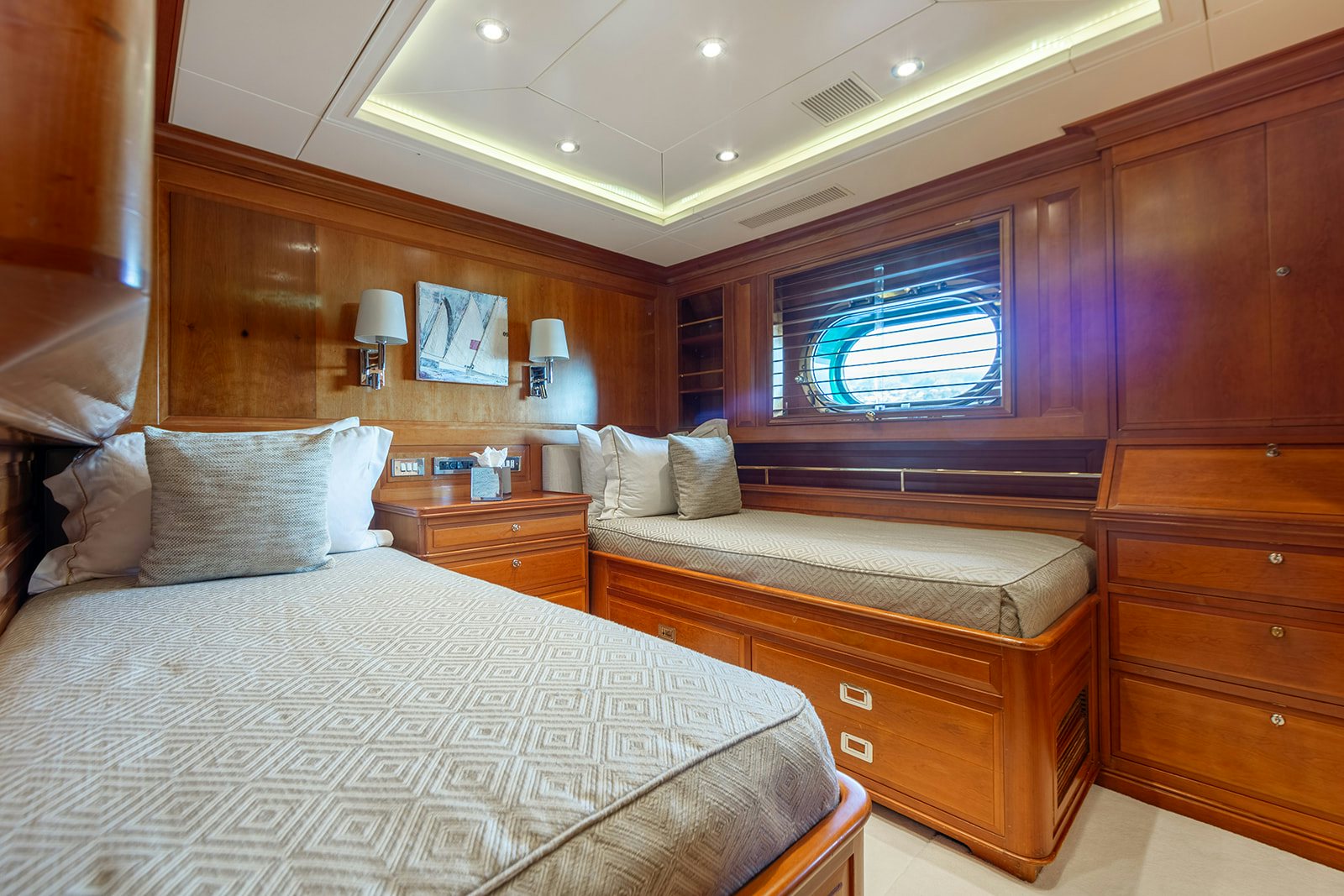 a bedroom with a bed and a dresser aboard NORFOLK STAR Yacht for Sale