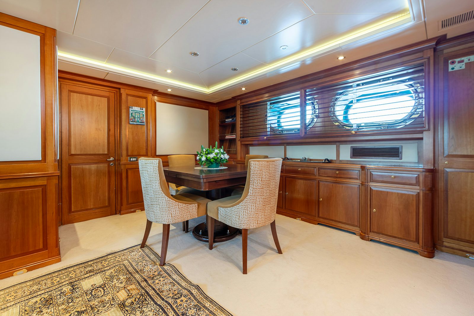 a room with a table and chairs aboard NORFOLK STAR Yacht for Sale