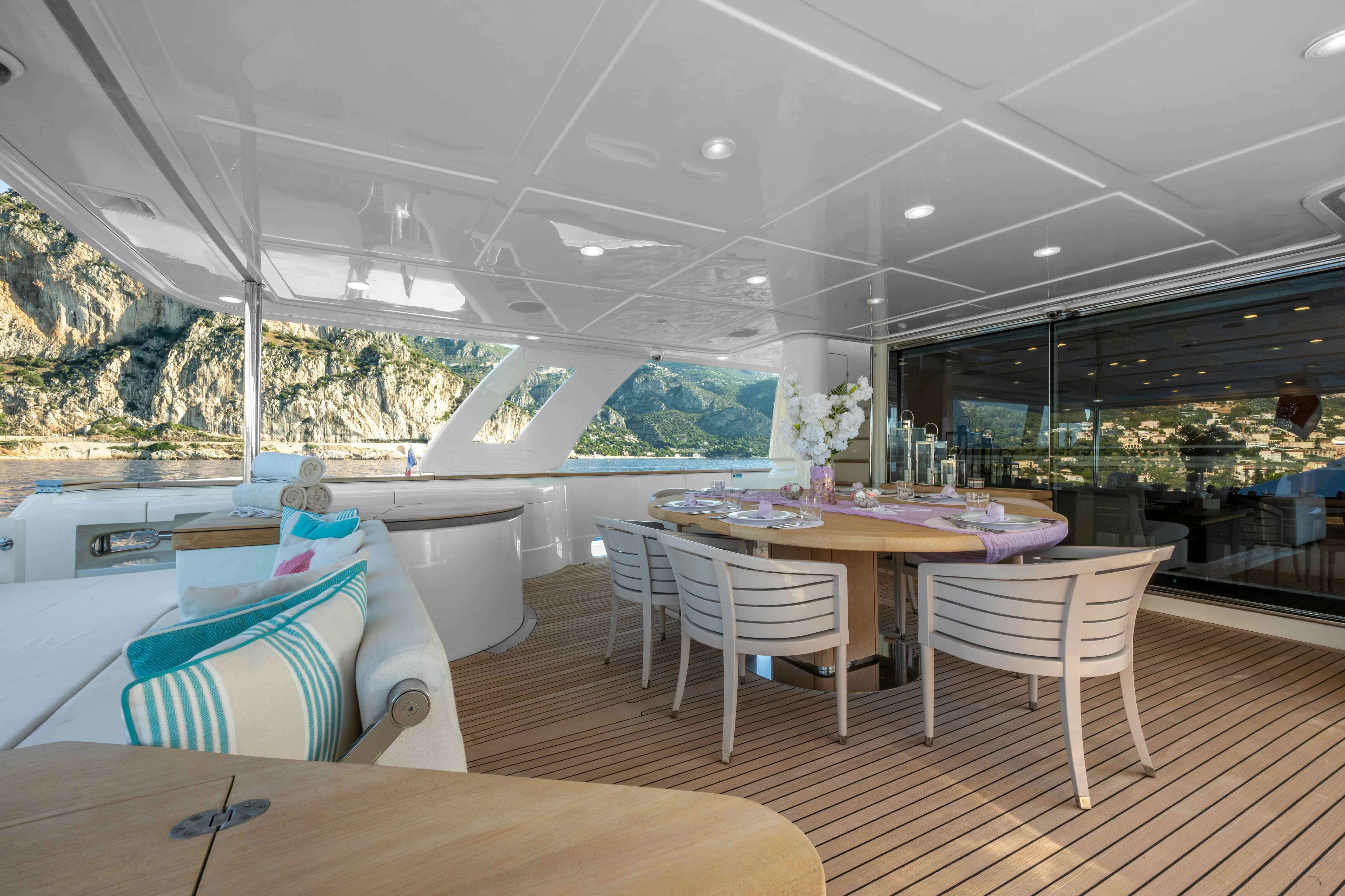 a room with a table and chairs aboard CENTURION Yacht for Sale