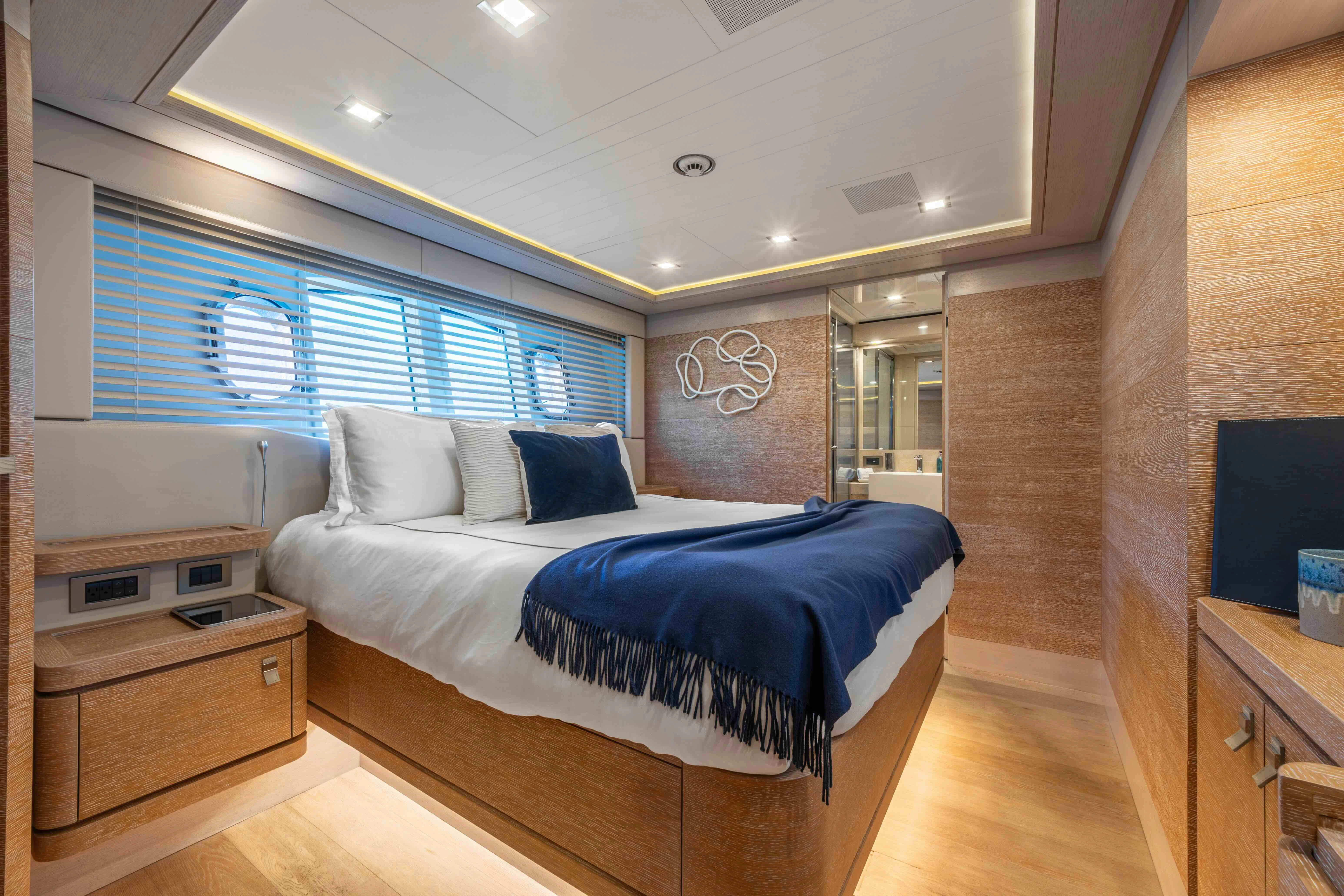 a bedroom with a bed and a desk aboard CENTURION Yacht for Sale