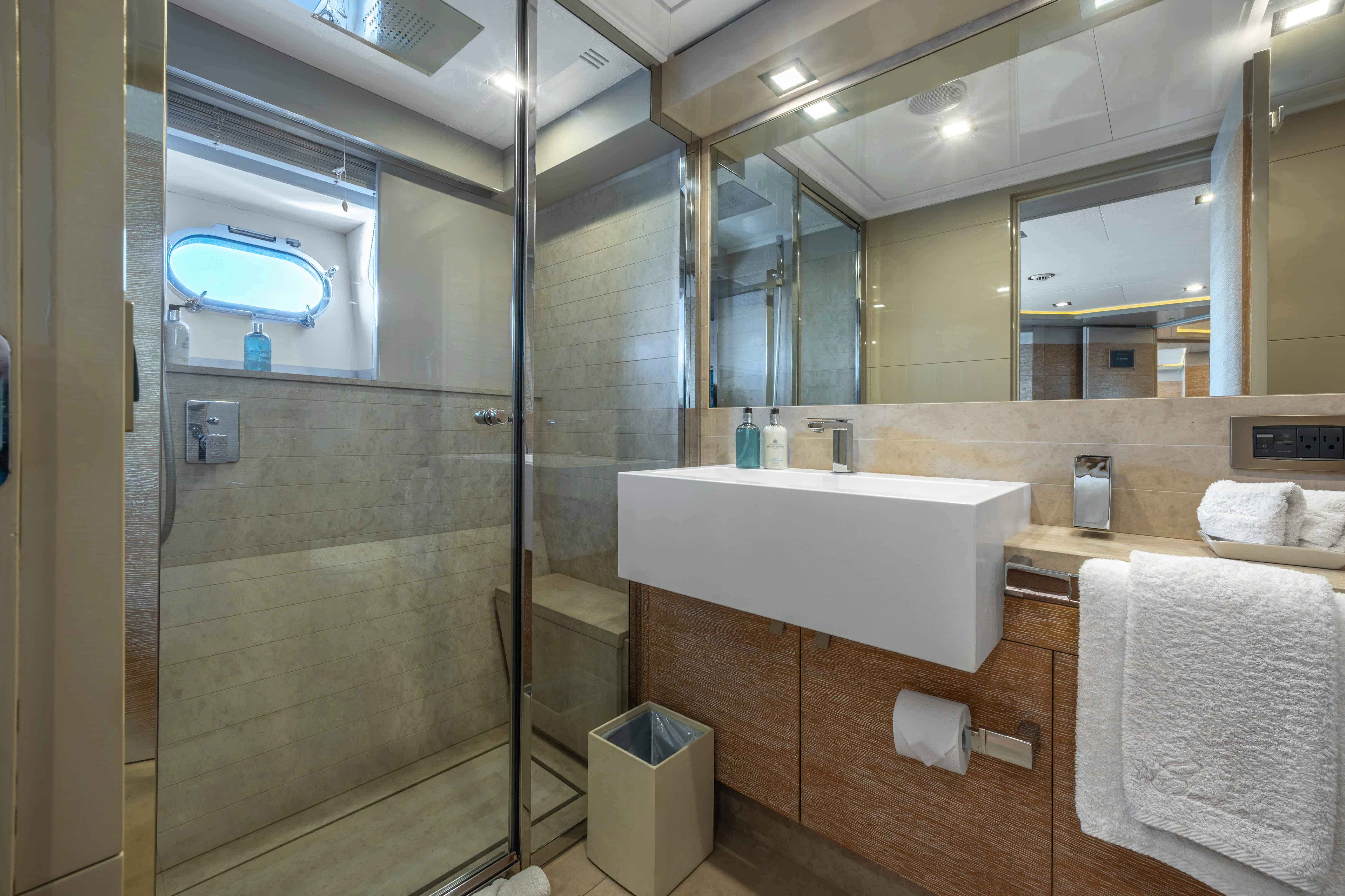 a bathroom with a glass shower aboard CENTURION Yacht for Sale