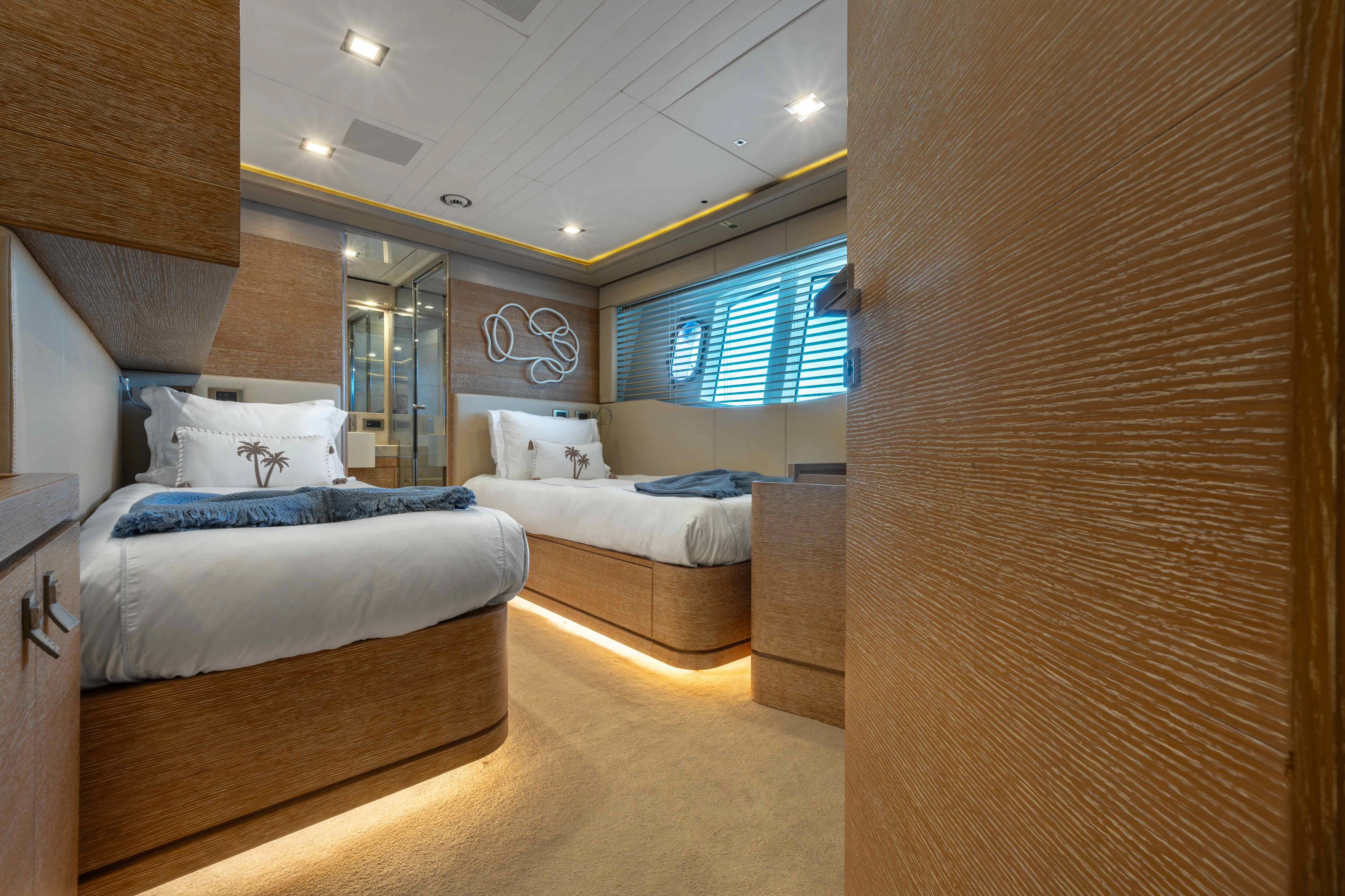 a room with a couple of beds aboard CENTURION Yacht for Sale