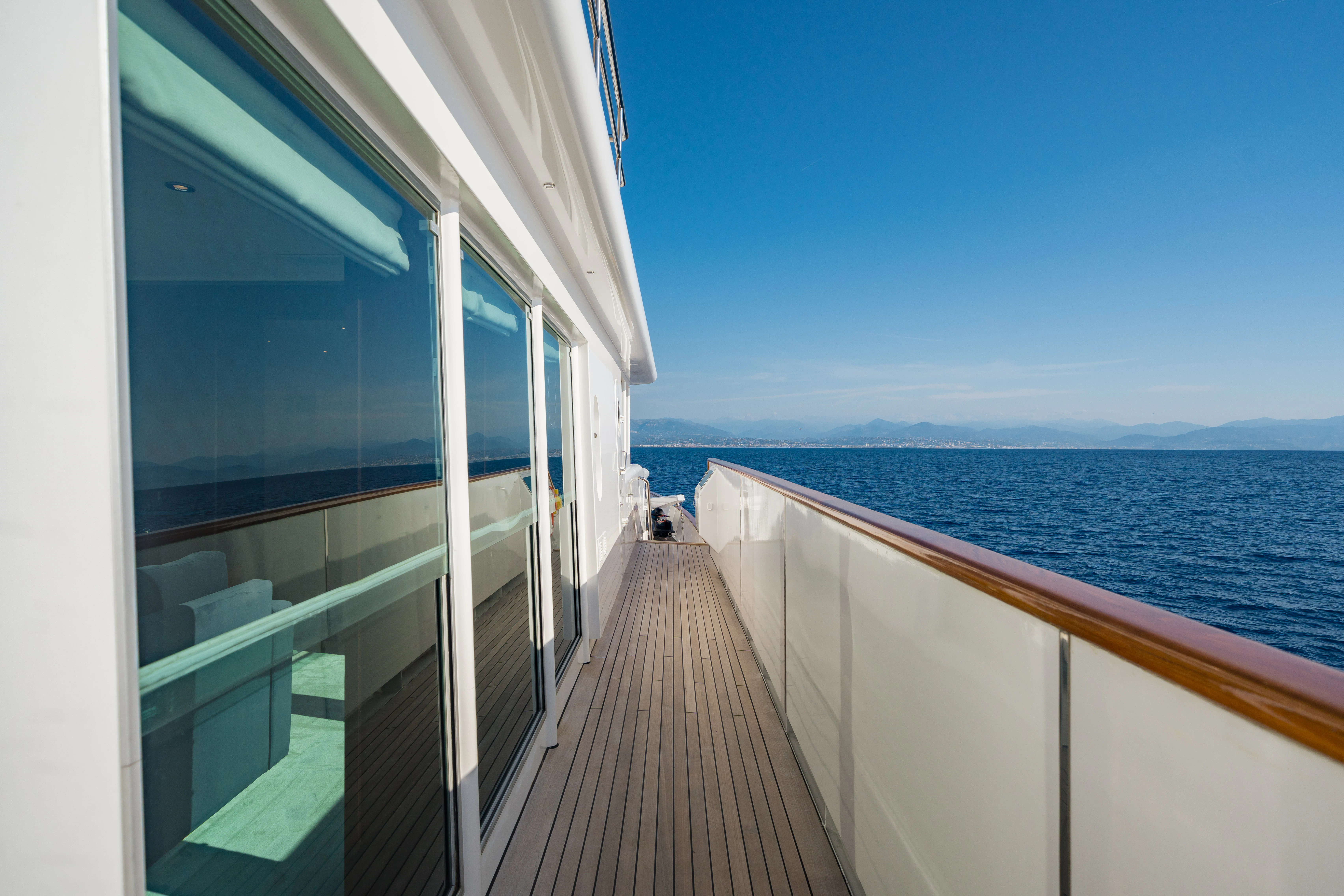a boardwalk leading to the ocean aboard KORU Yacht for Sale