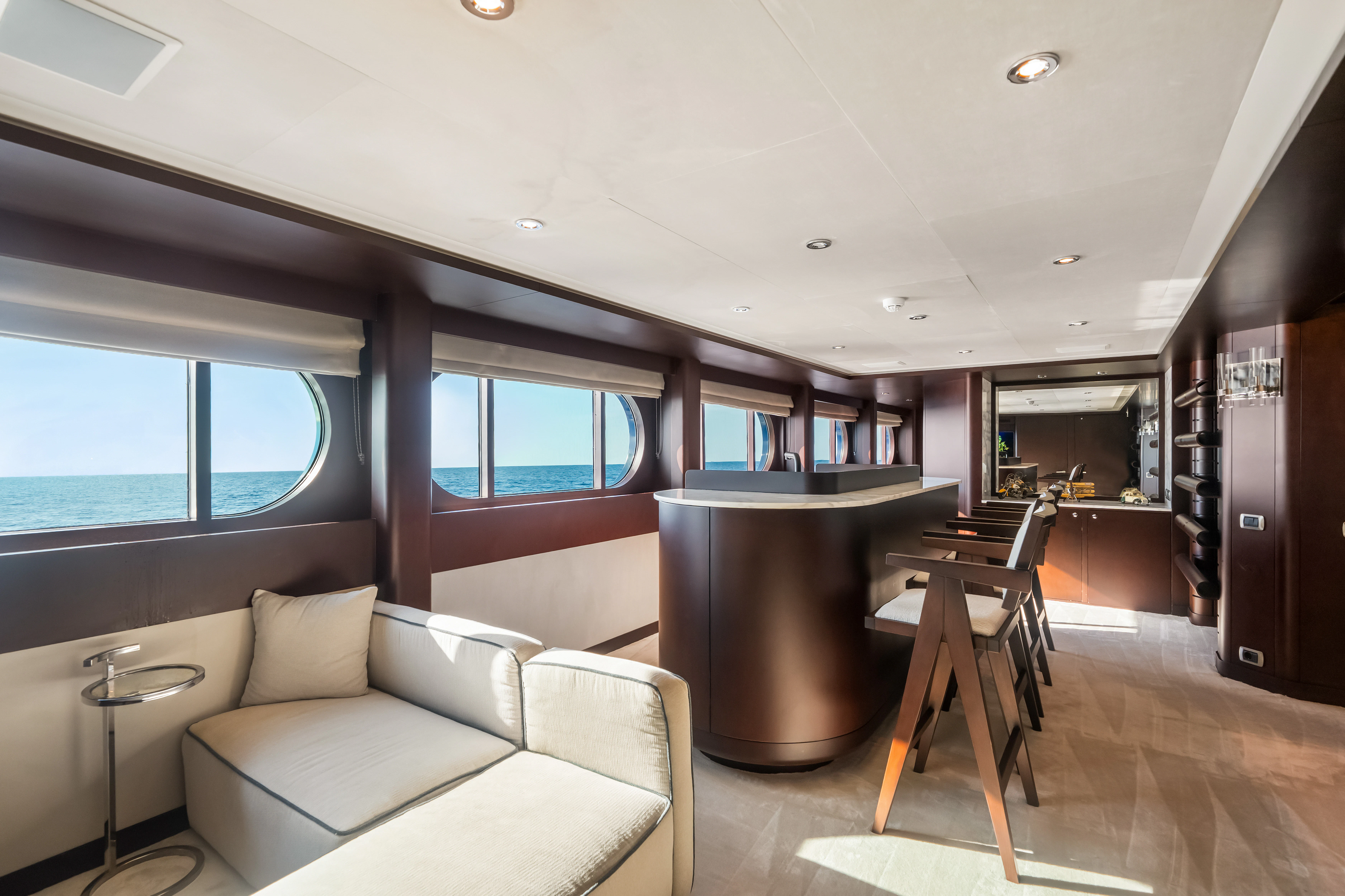 a living room with a couch and a table aboard KORU Yacht for Sale