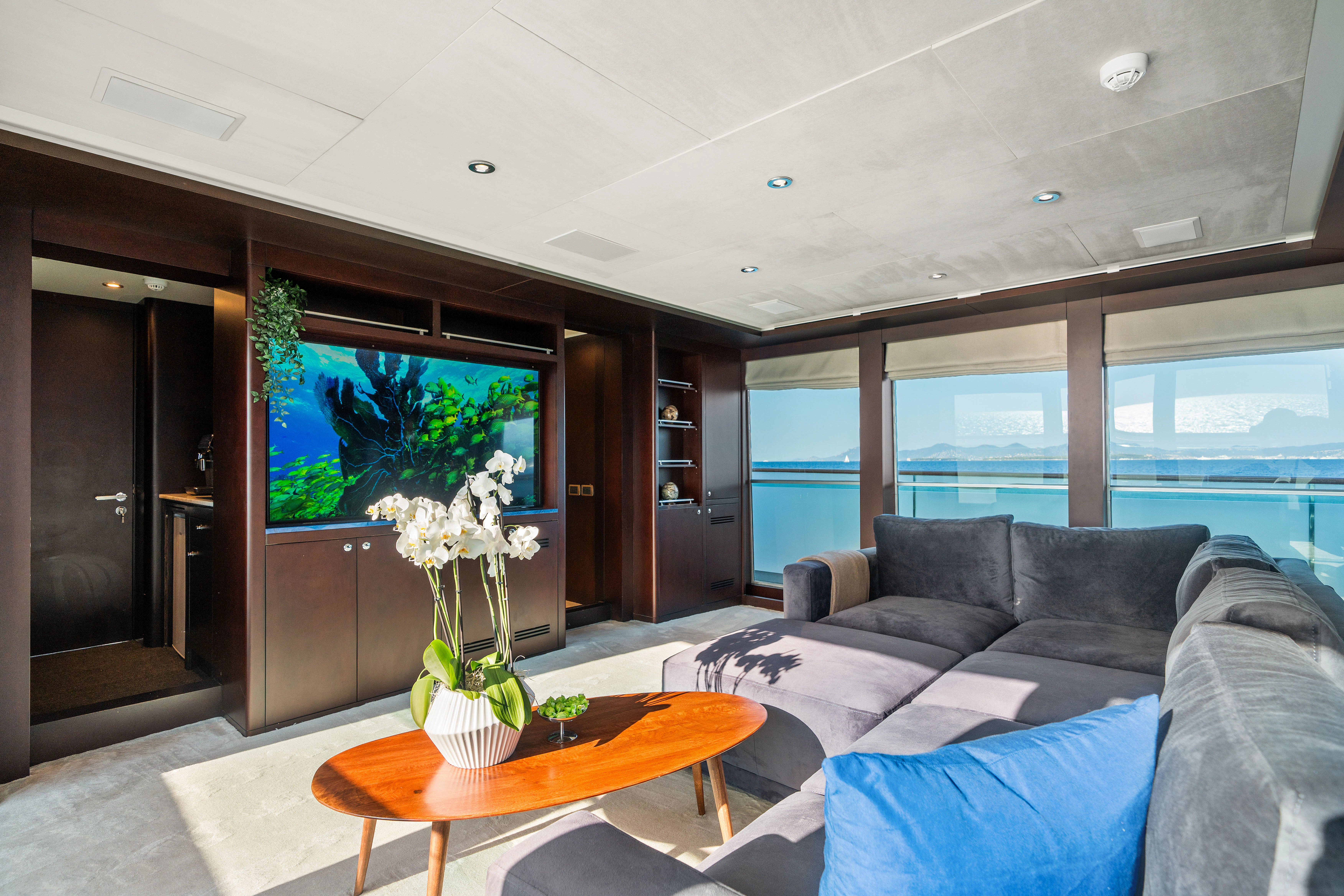 a living room with a large screen aboard KORU Yacht for Sale