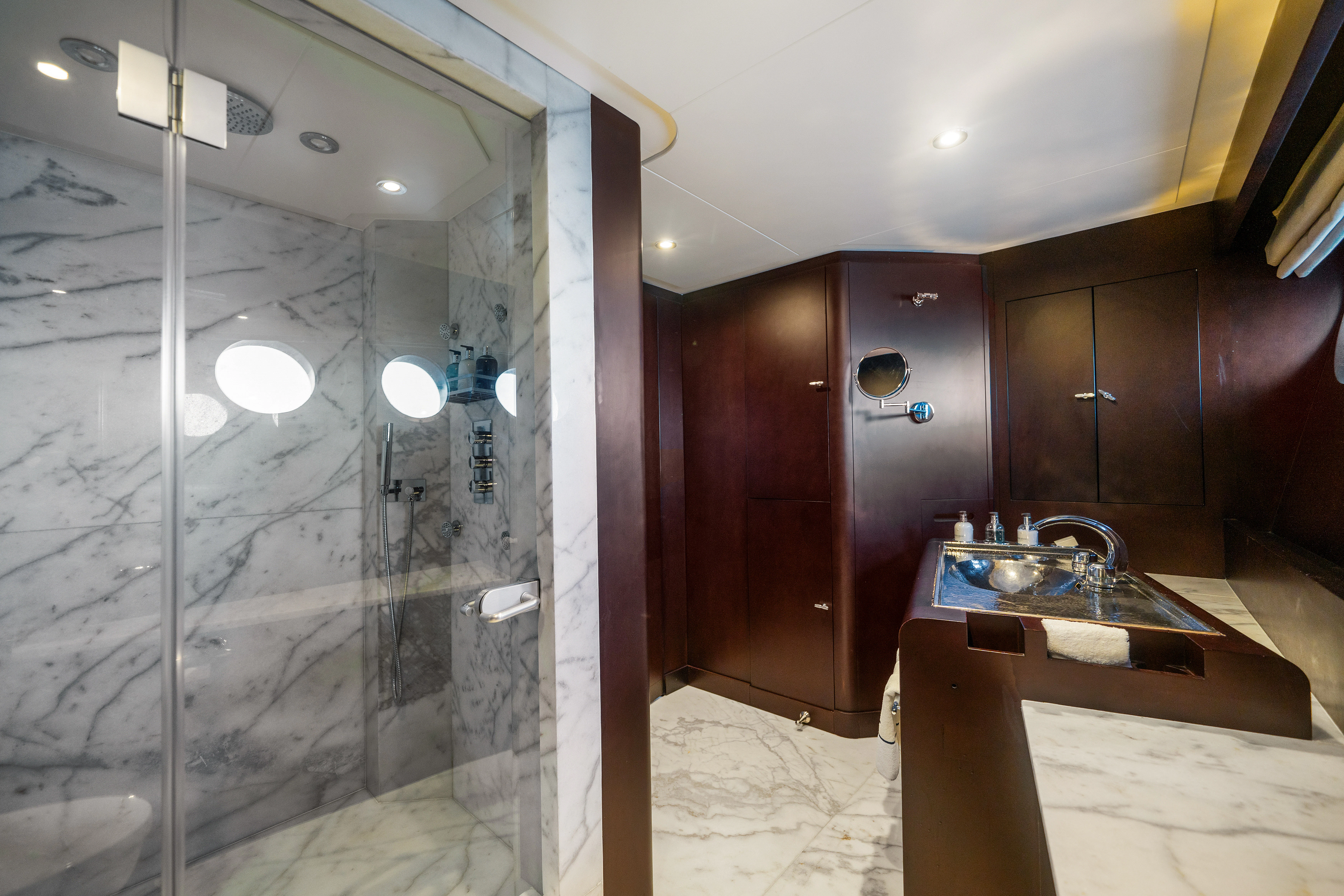a bathroom with a sink and a shower aboard KORU Yacht for Sale