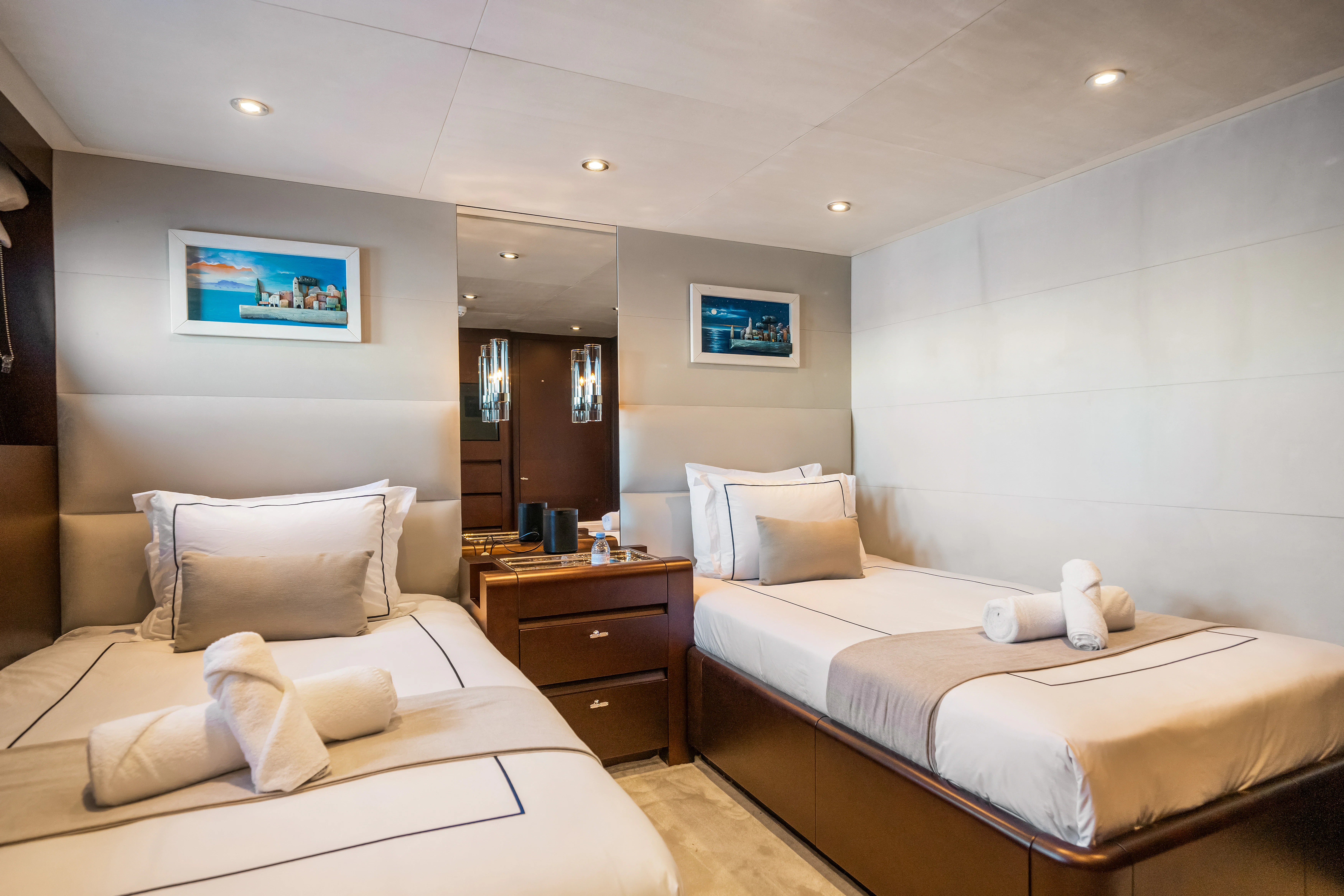 a bedroom with two beds aboard KORU Yacht for Sale