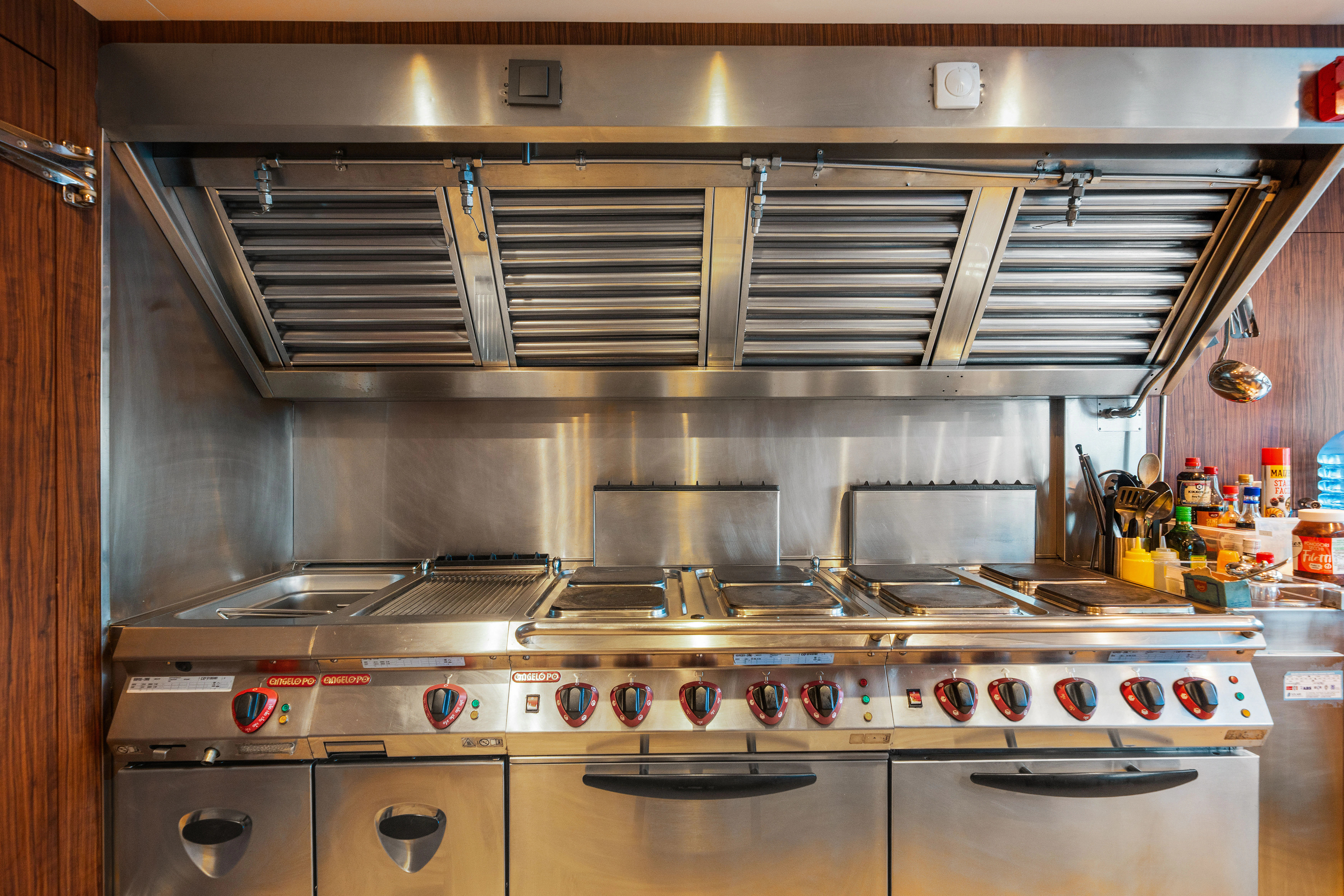 a kitchen with a stainless steel stove aboard KORU Yacht for Sale