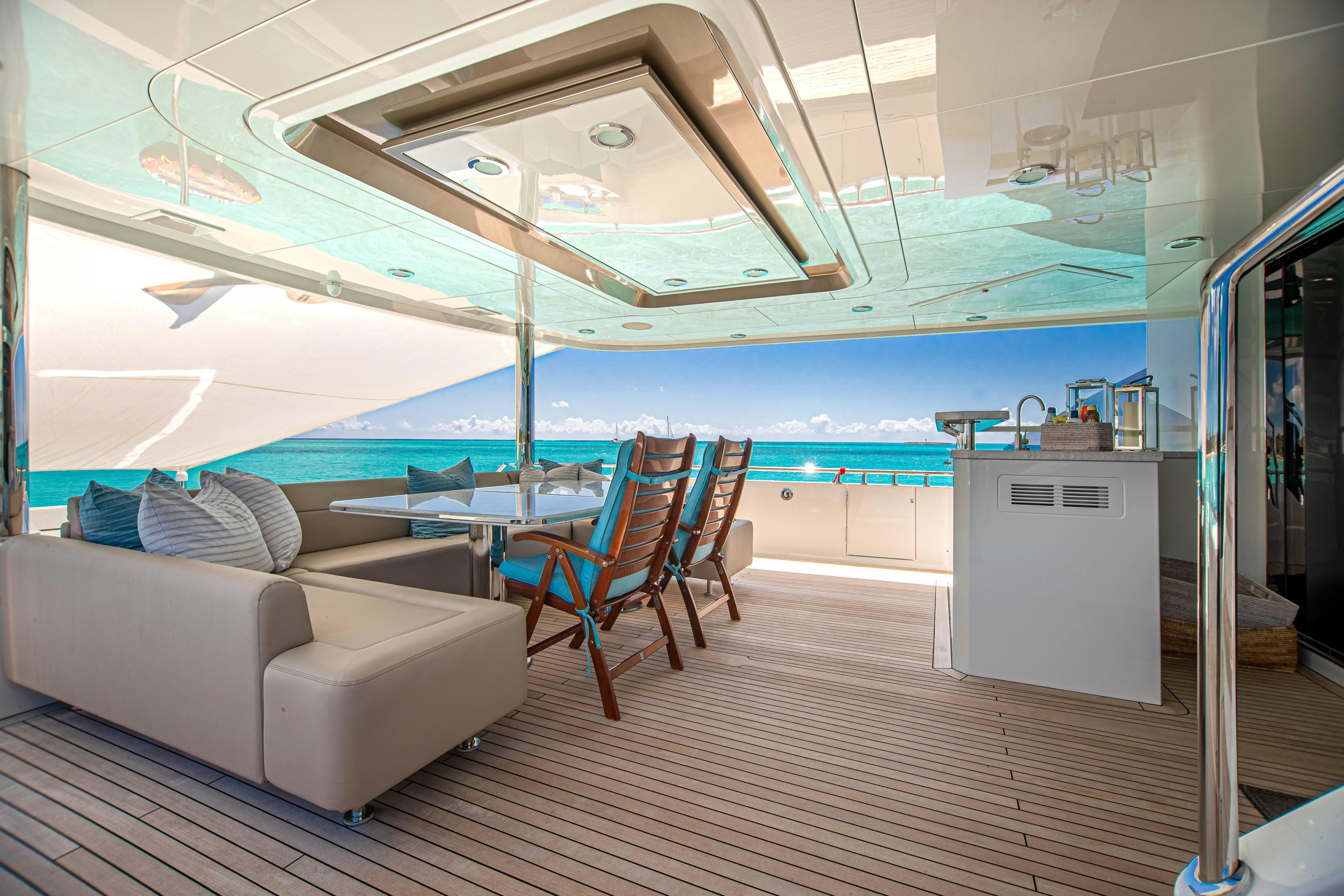 a room with a couch and a table and chairs aboard I C Yacht for Charter