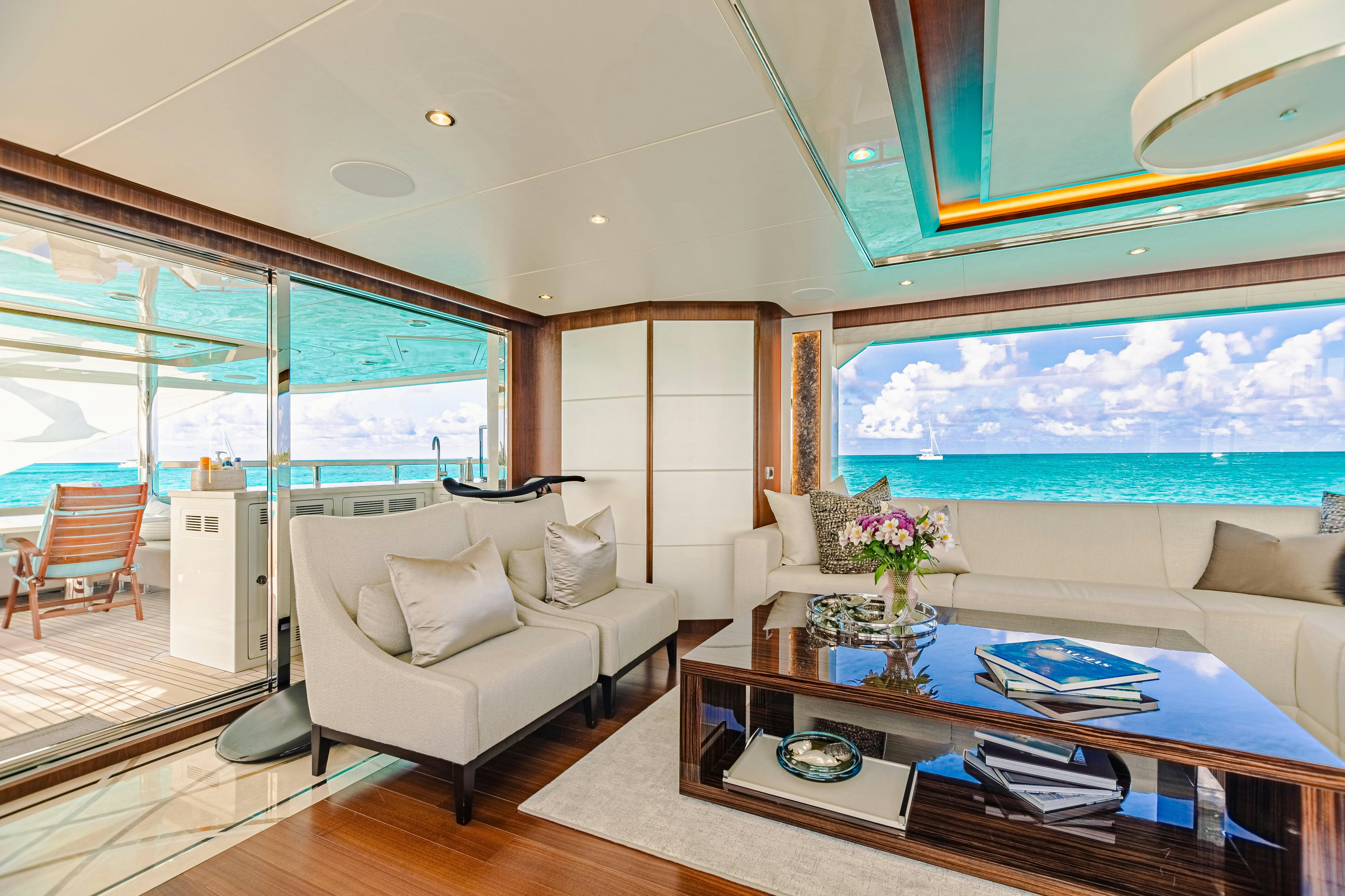 a living room with a large glass window aboard I C Yacht for Charter