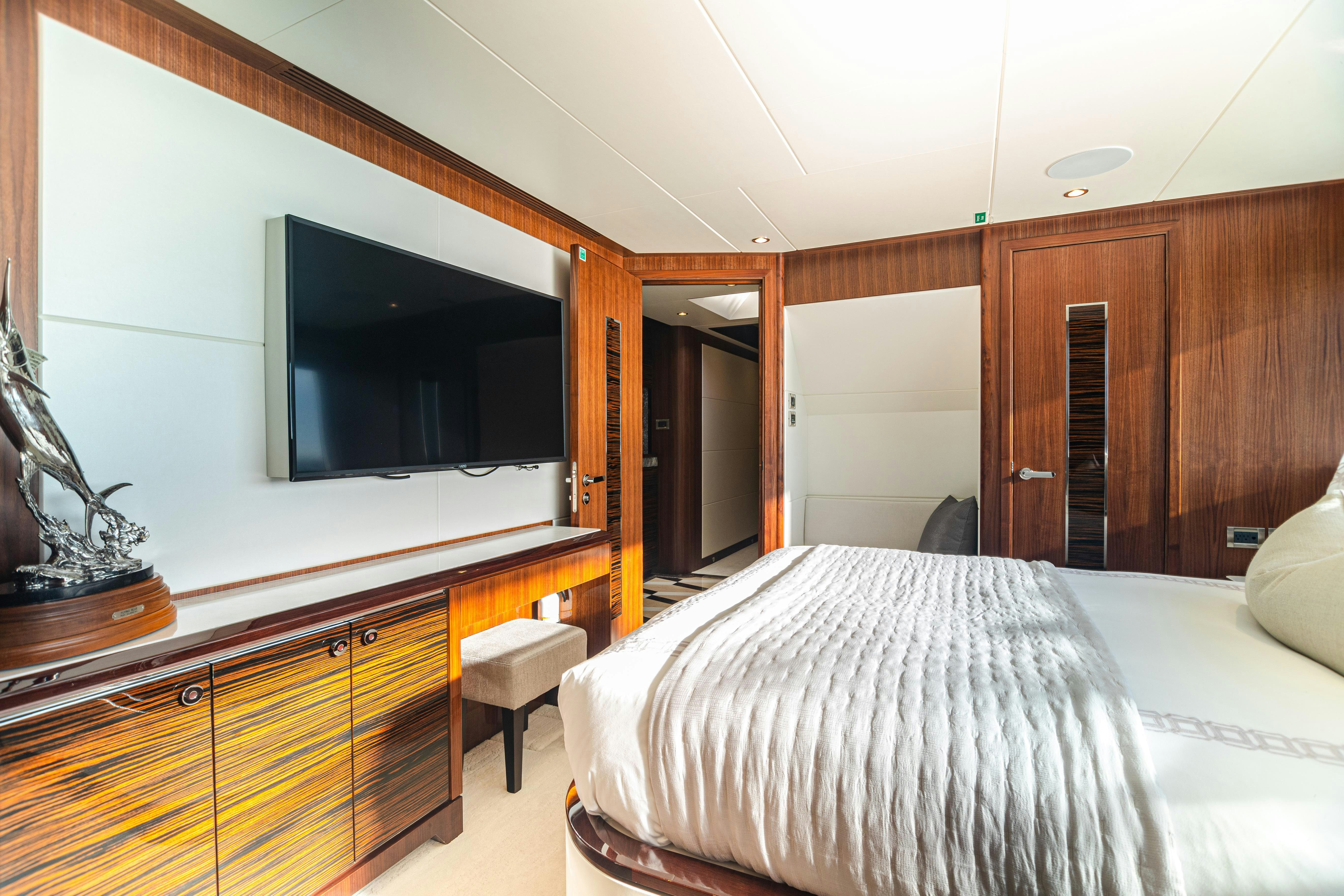 a bedroom with a tv on the wall aboard I C Yacht for Charter