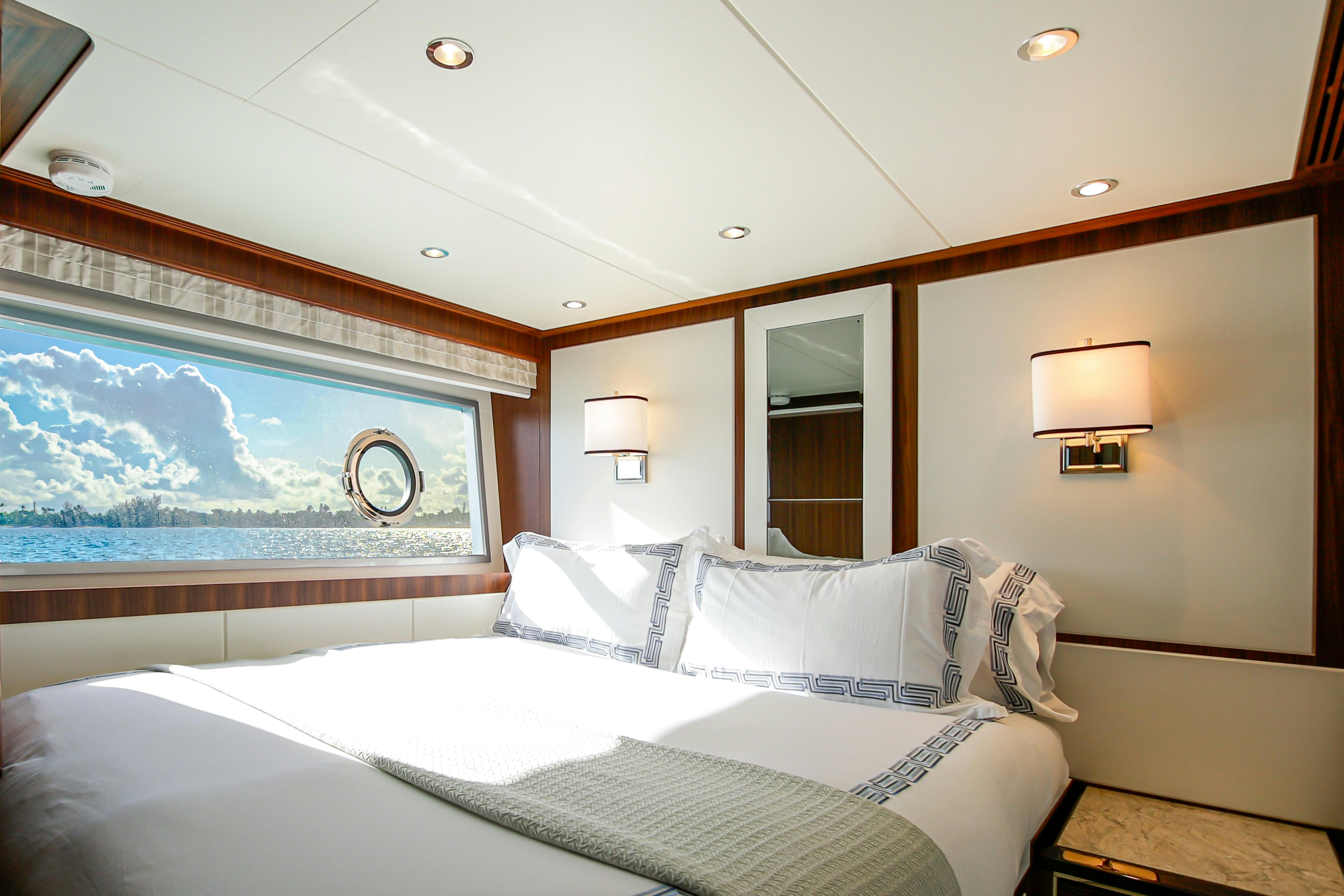 a room with a bed and a painting on the wall aboard I C Yacht for Charter