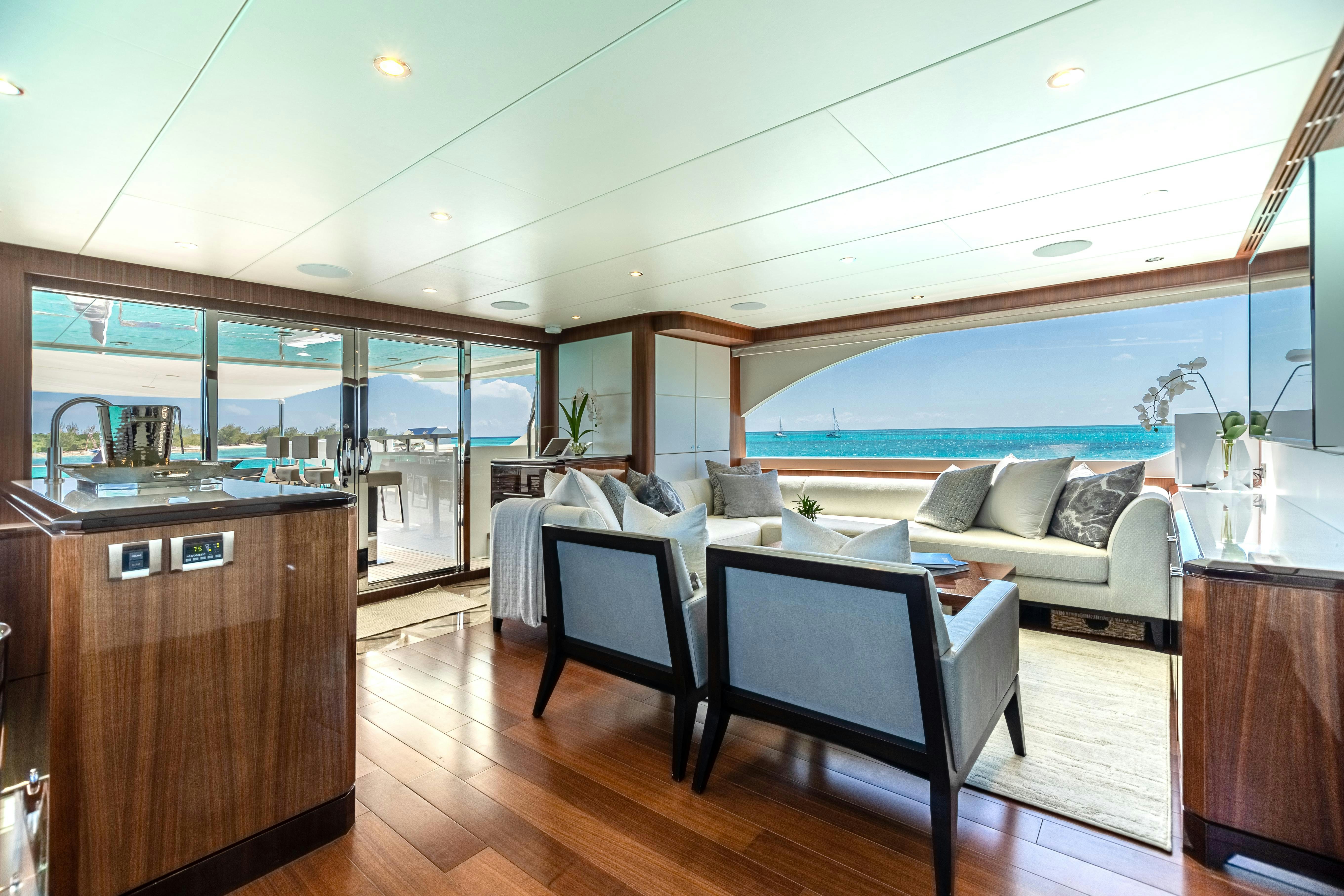 a room with a couch and a table and a chair aboard I C Yacht for Charter