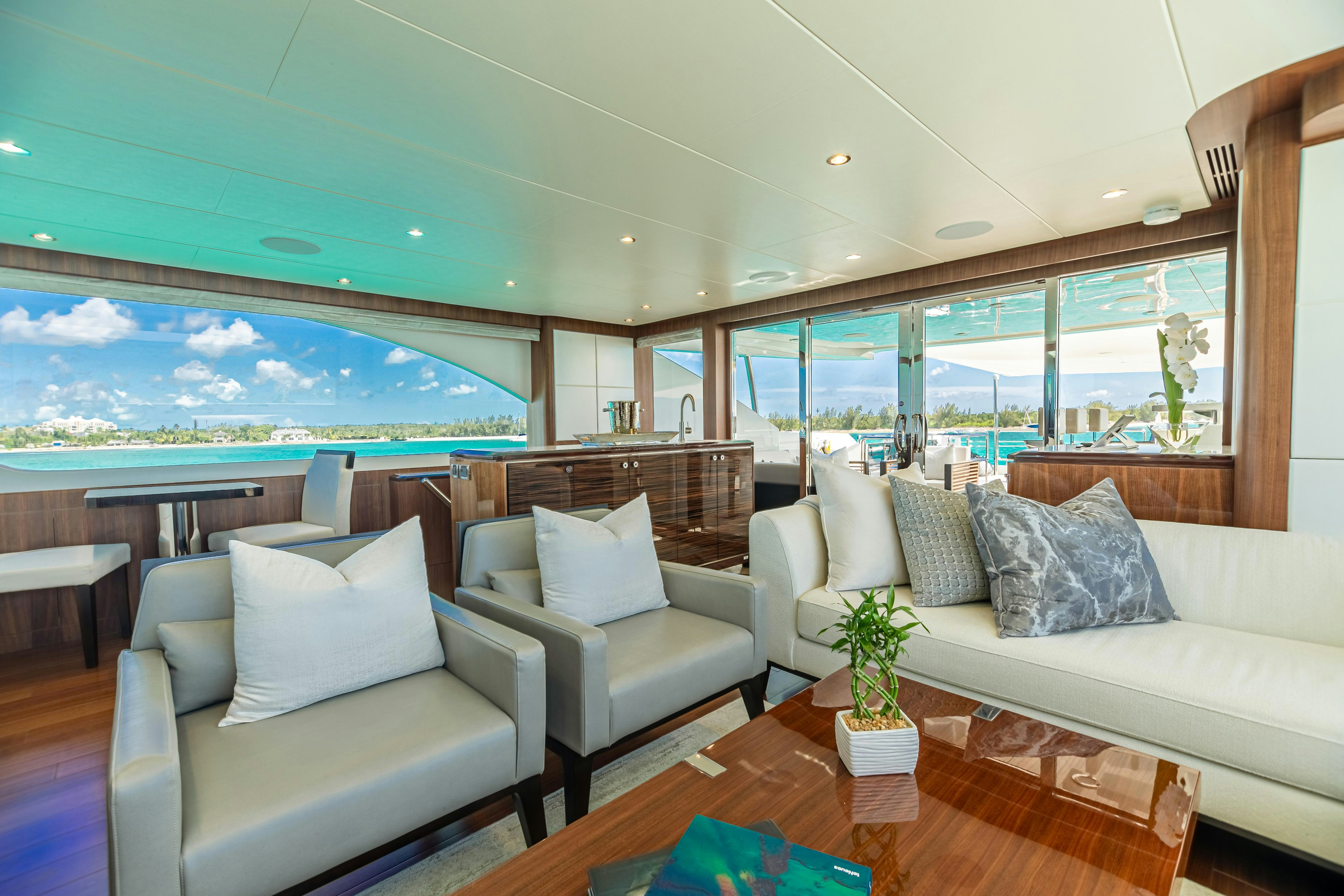 a living room with couches and a view of the ocean aboard I C Yacht for Charter