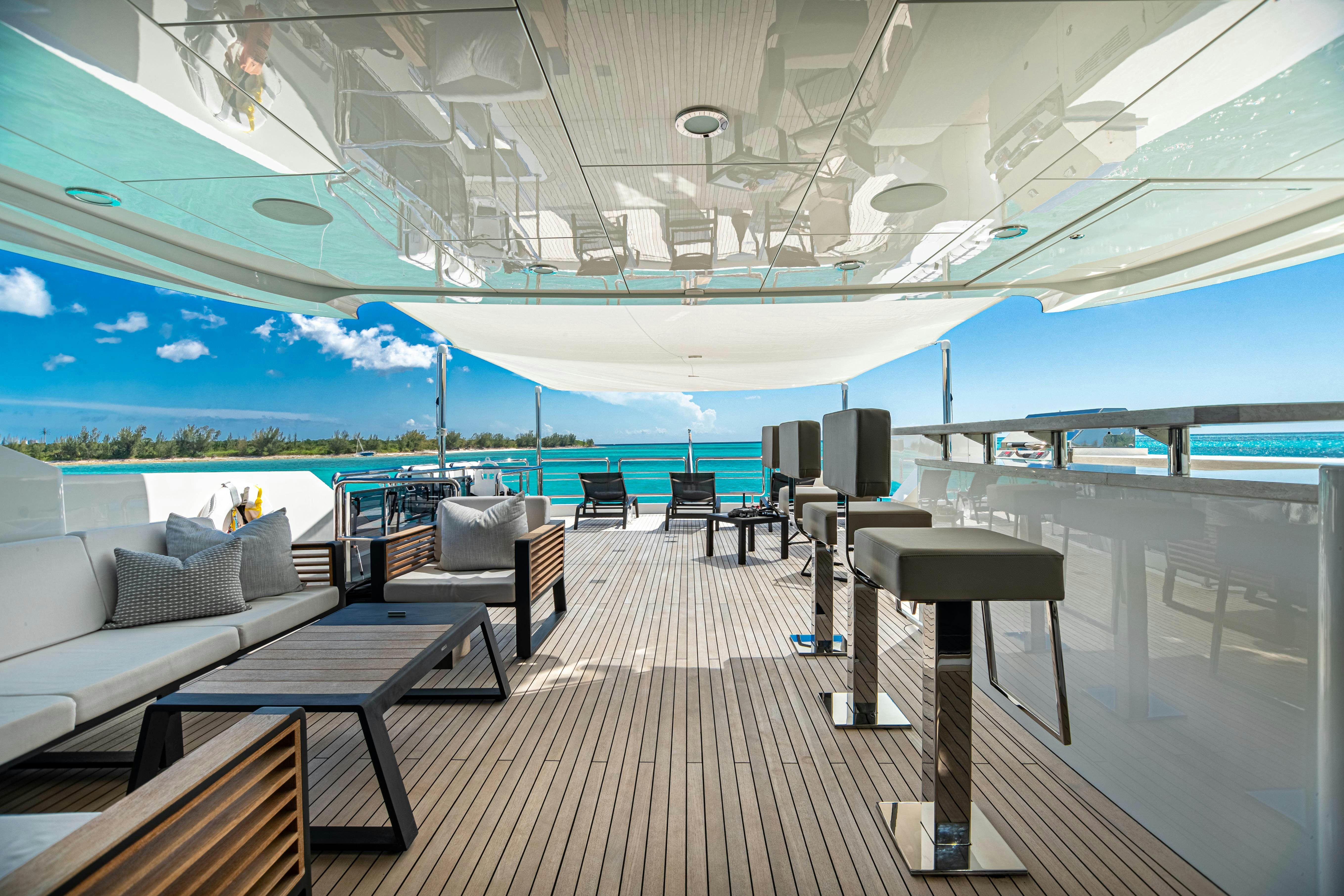 a deck with a large pool aboard I C Yacht for Charter
