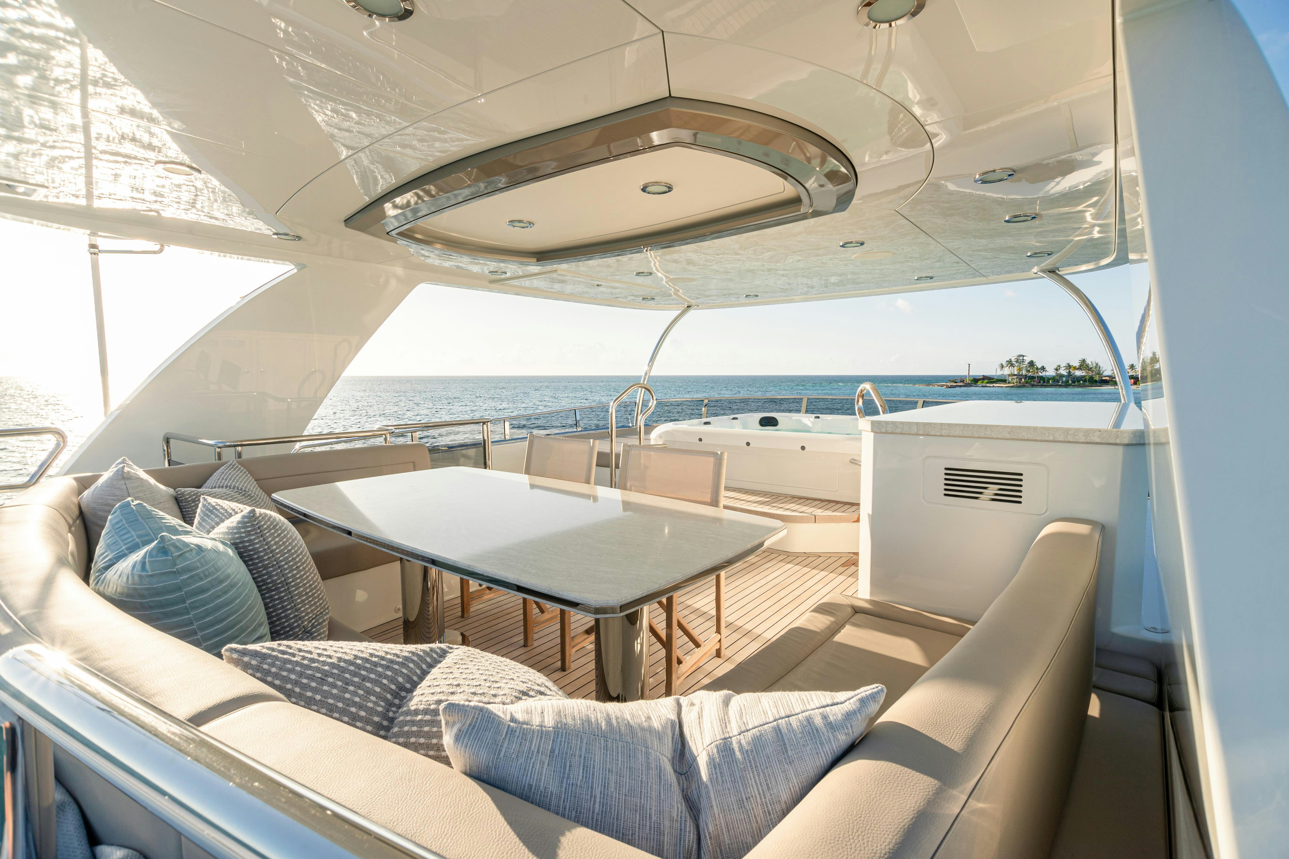 a boat with a table and chairs aboard I C Yacht for Charter