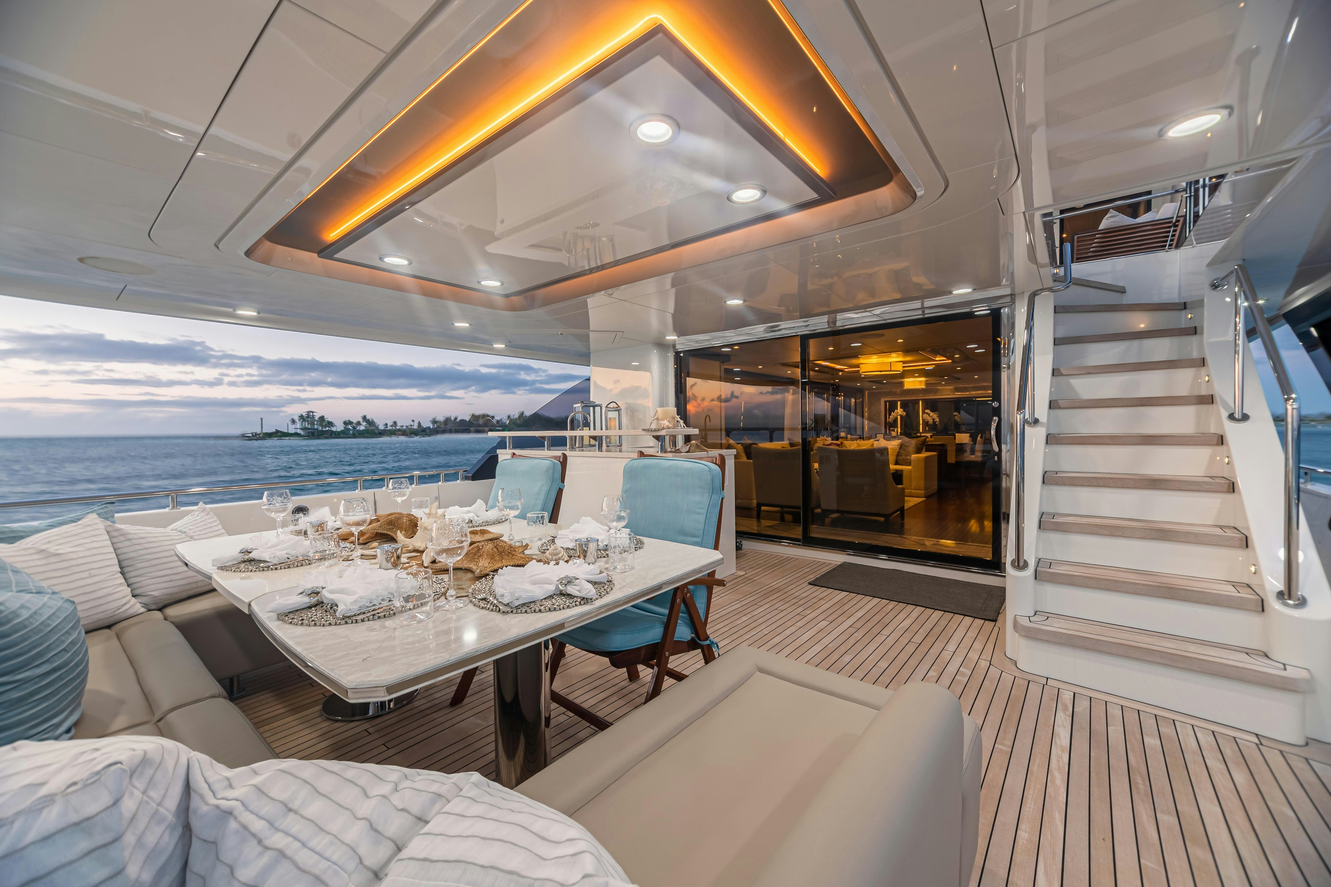 a room with a table and chairs aboard I C Yacht for Charter
