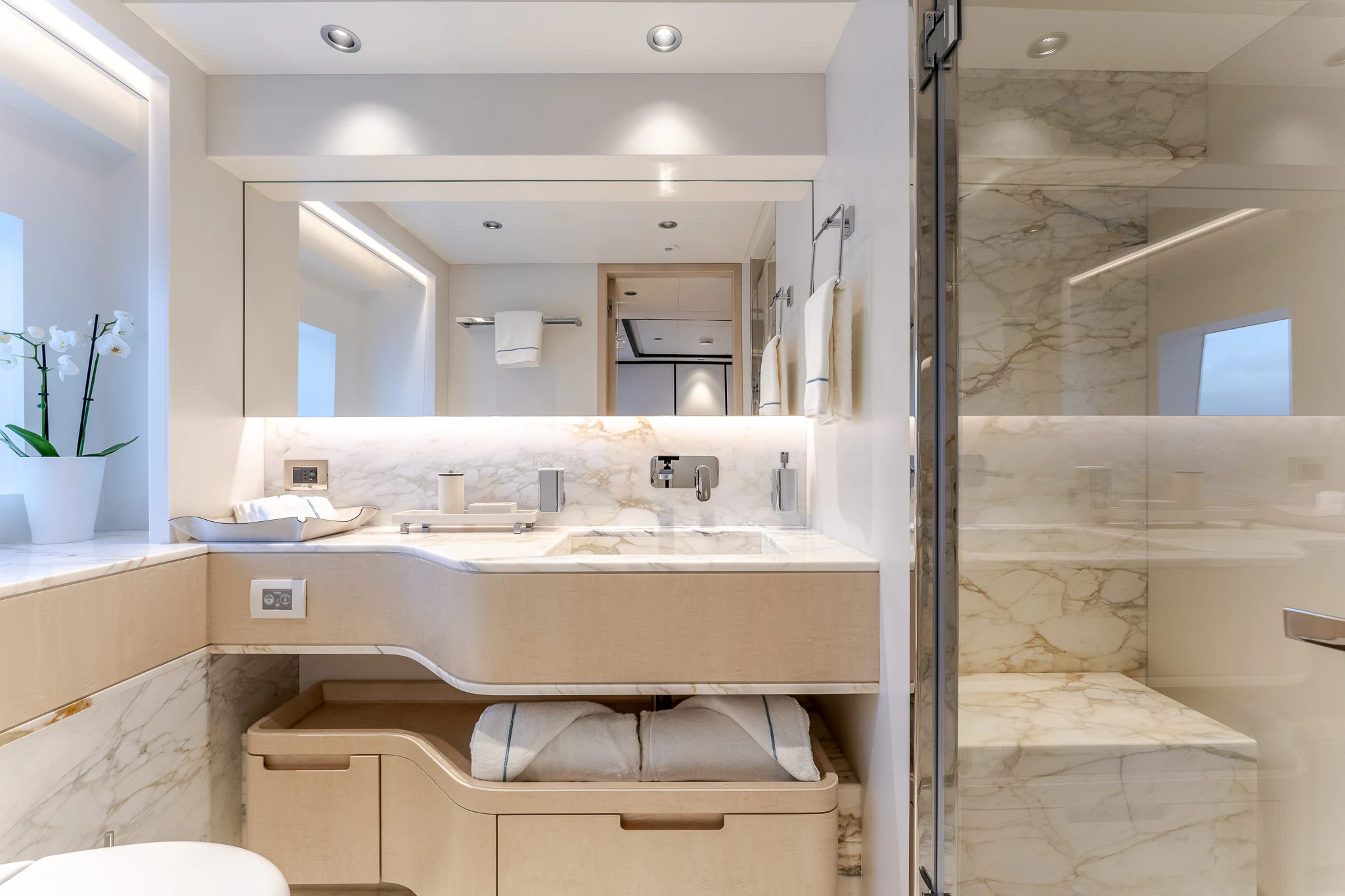 a bathroom with a glass shower aboard OPTIMISM Yacht for Sale