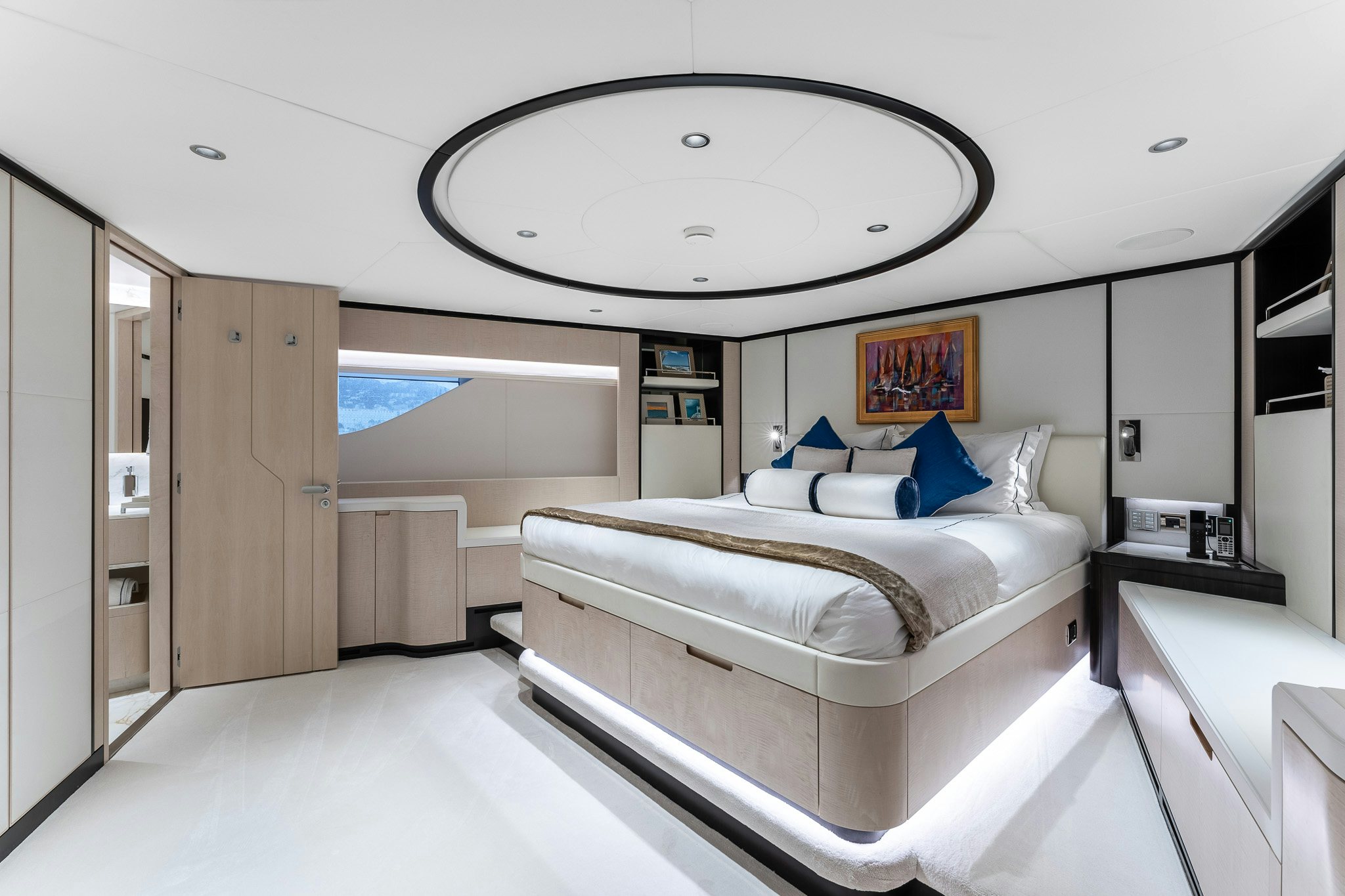 a large white bedroom with a large window aboard OPTIMISM Yacht for Charter