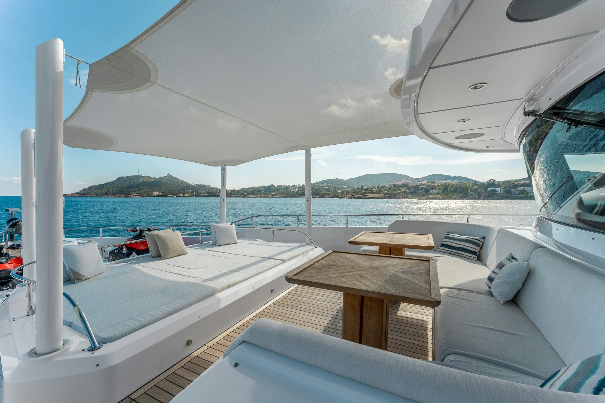 a boat with a table and chairs on the deck aboard OPTIMISM Yacht for Charter
