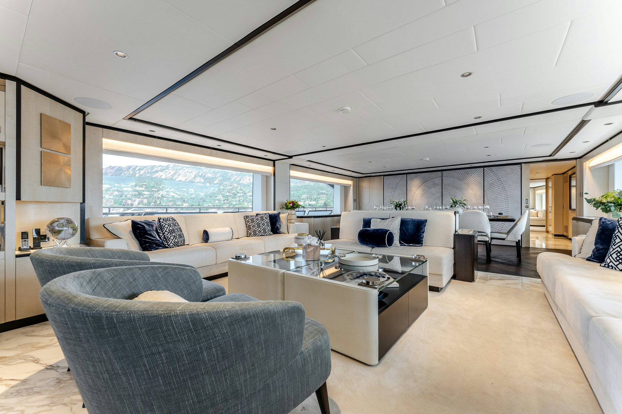 a living room with a large window aboard OPTIMISM Yacht for Charter