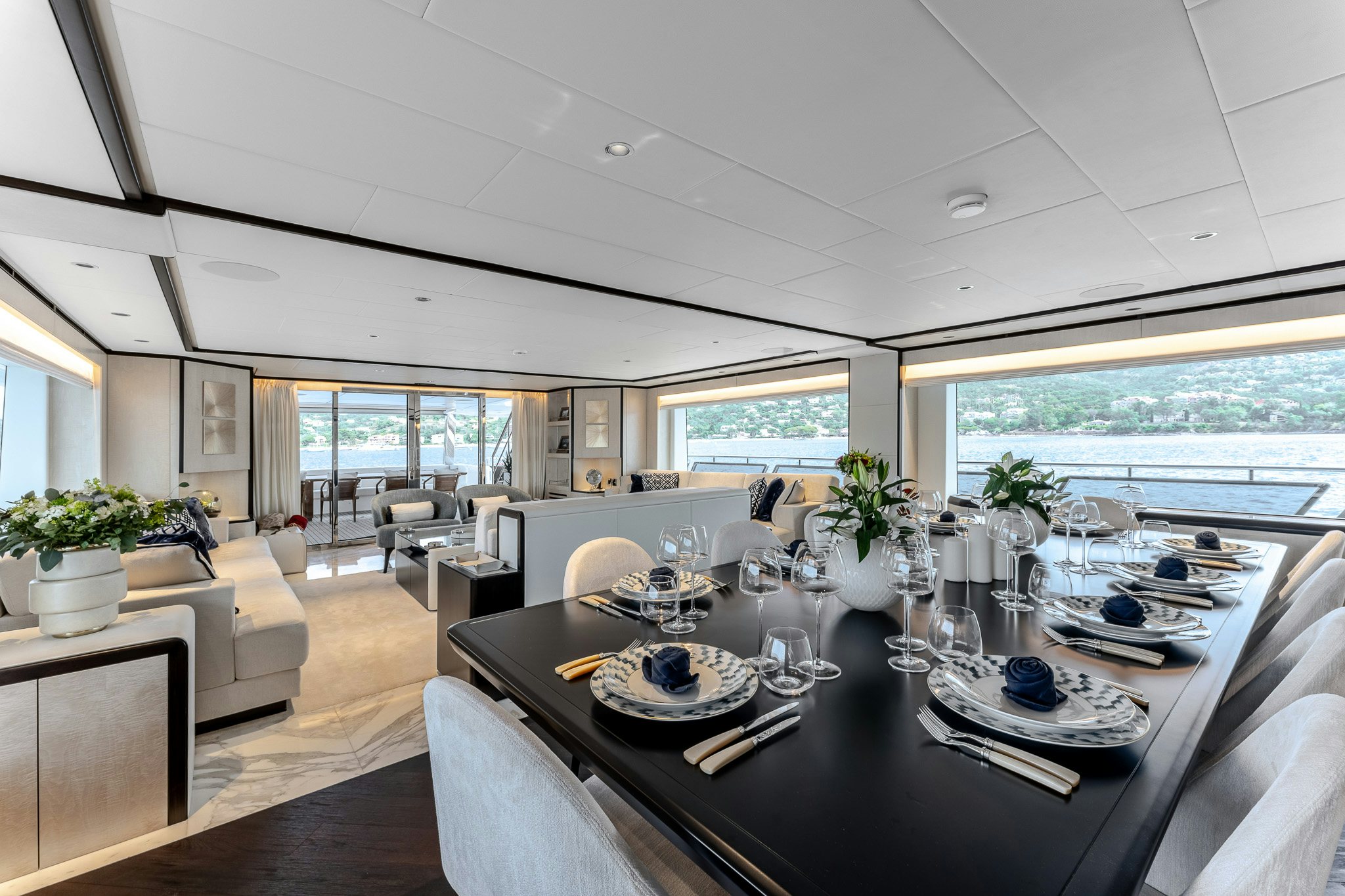 a large dining table in a room aboard OPTIMISM Yacht for Charter