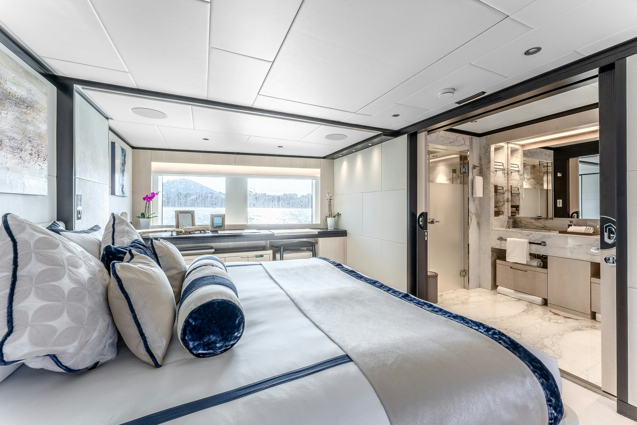a large bed in a room aboard OPTIMISM Yacht for Charter
