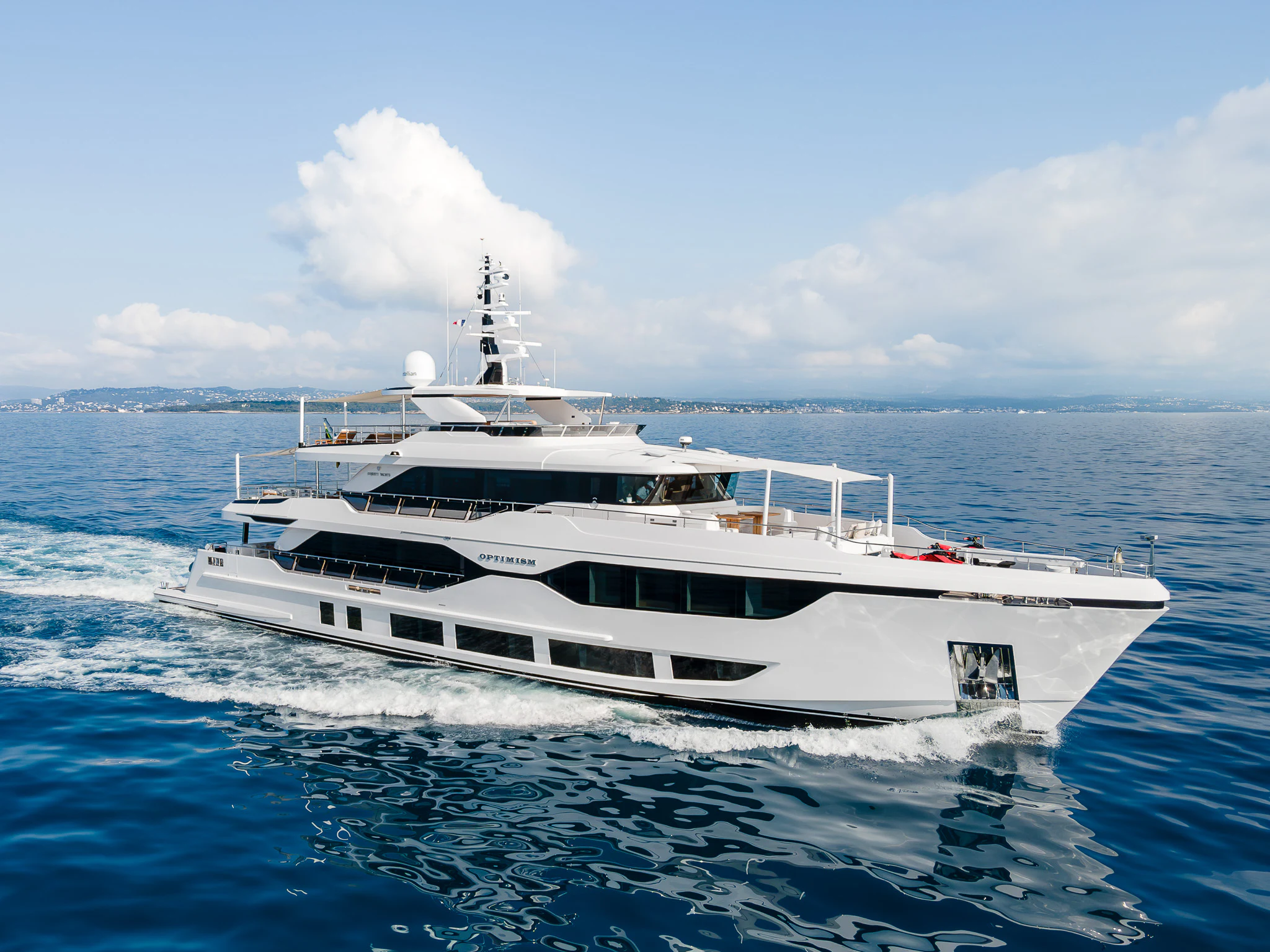 a white yacht in the water aboard OPTIMISM Yacht for Sale