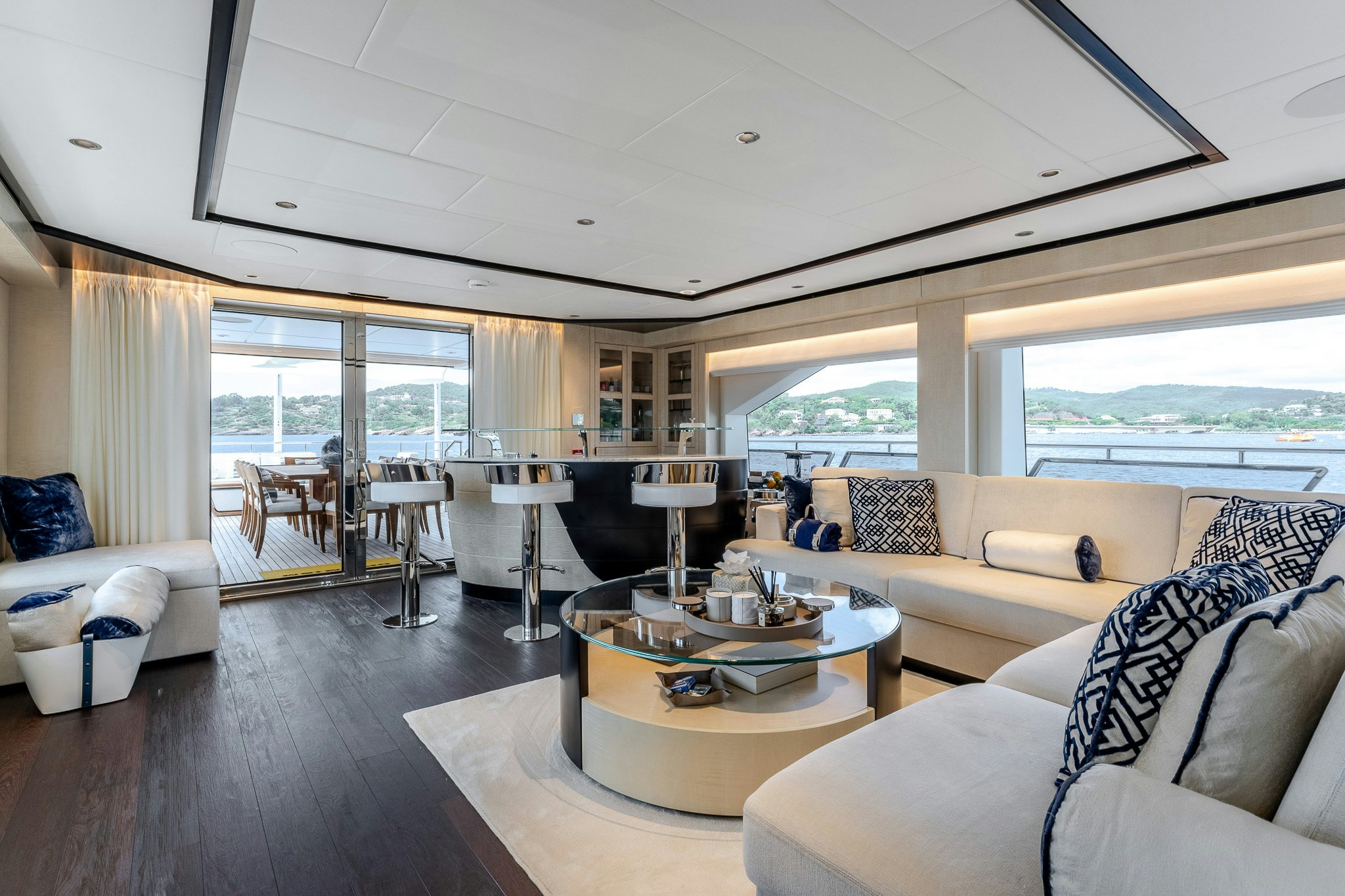 a living room with a large window aboard OPTIMISM Yacht for Charter