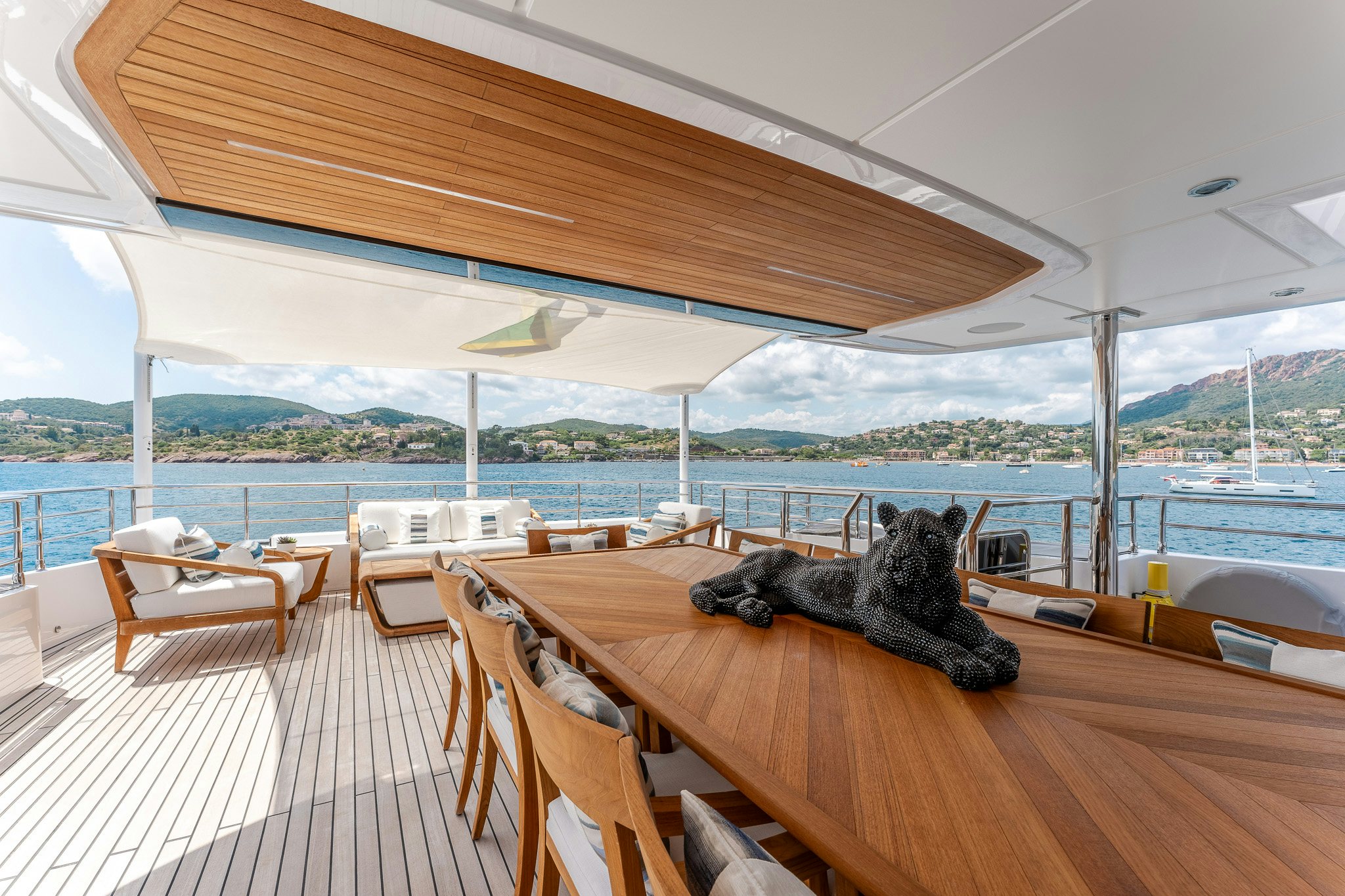 a cat lying on a table aboard OPTIMISM Yacht for Charter