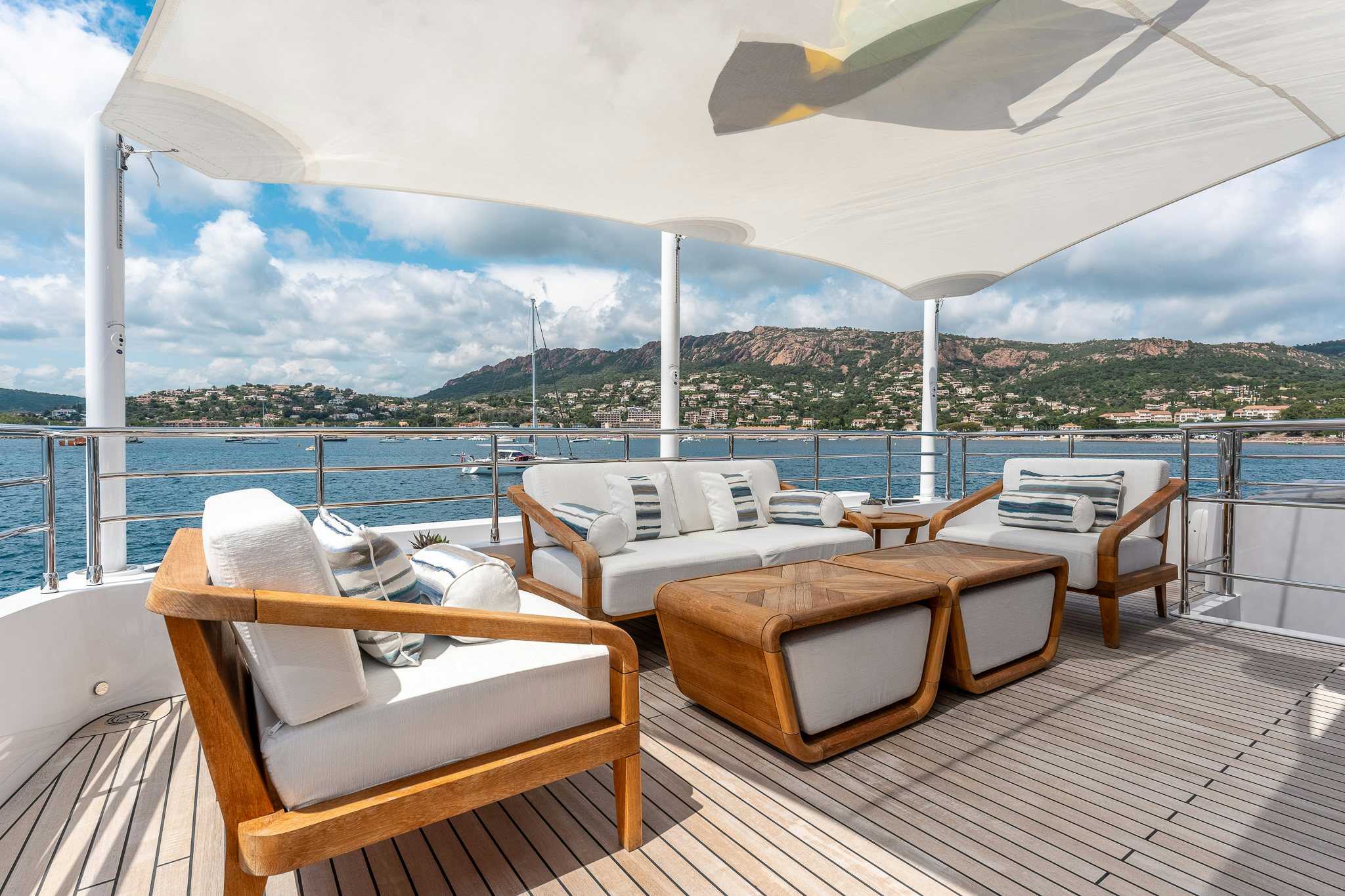 a room with a view of the ocean and a city aboard OPTIMISM Yacht for Charter