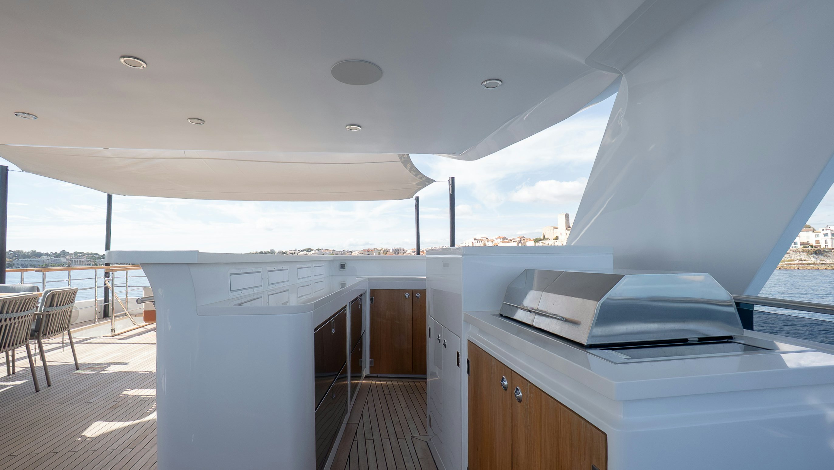 a large white room with a large window and a large pool aboard RAY Yacht for Sale