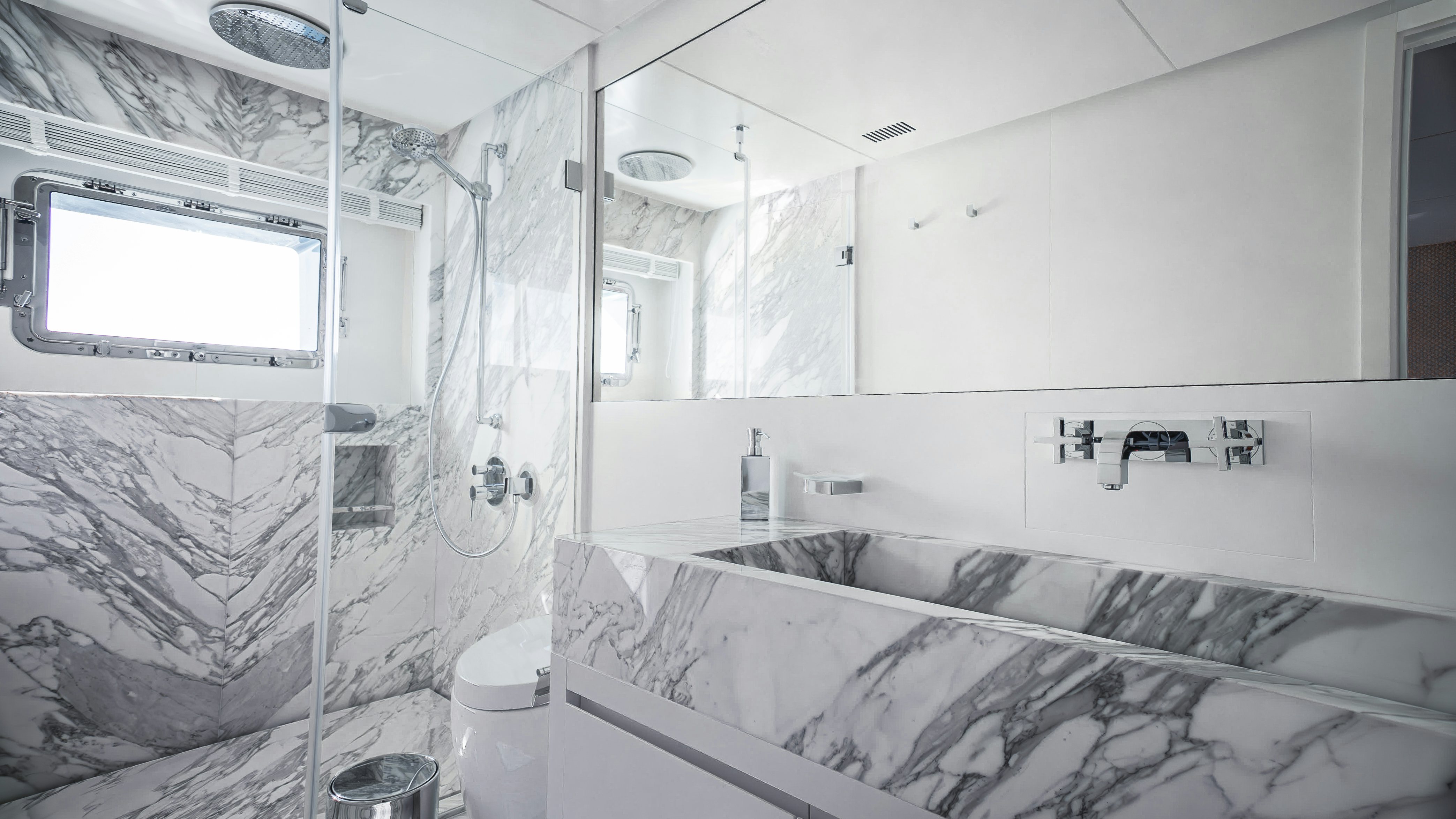 a bathroom with a glass shower aboard RAY Yacht for Sale