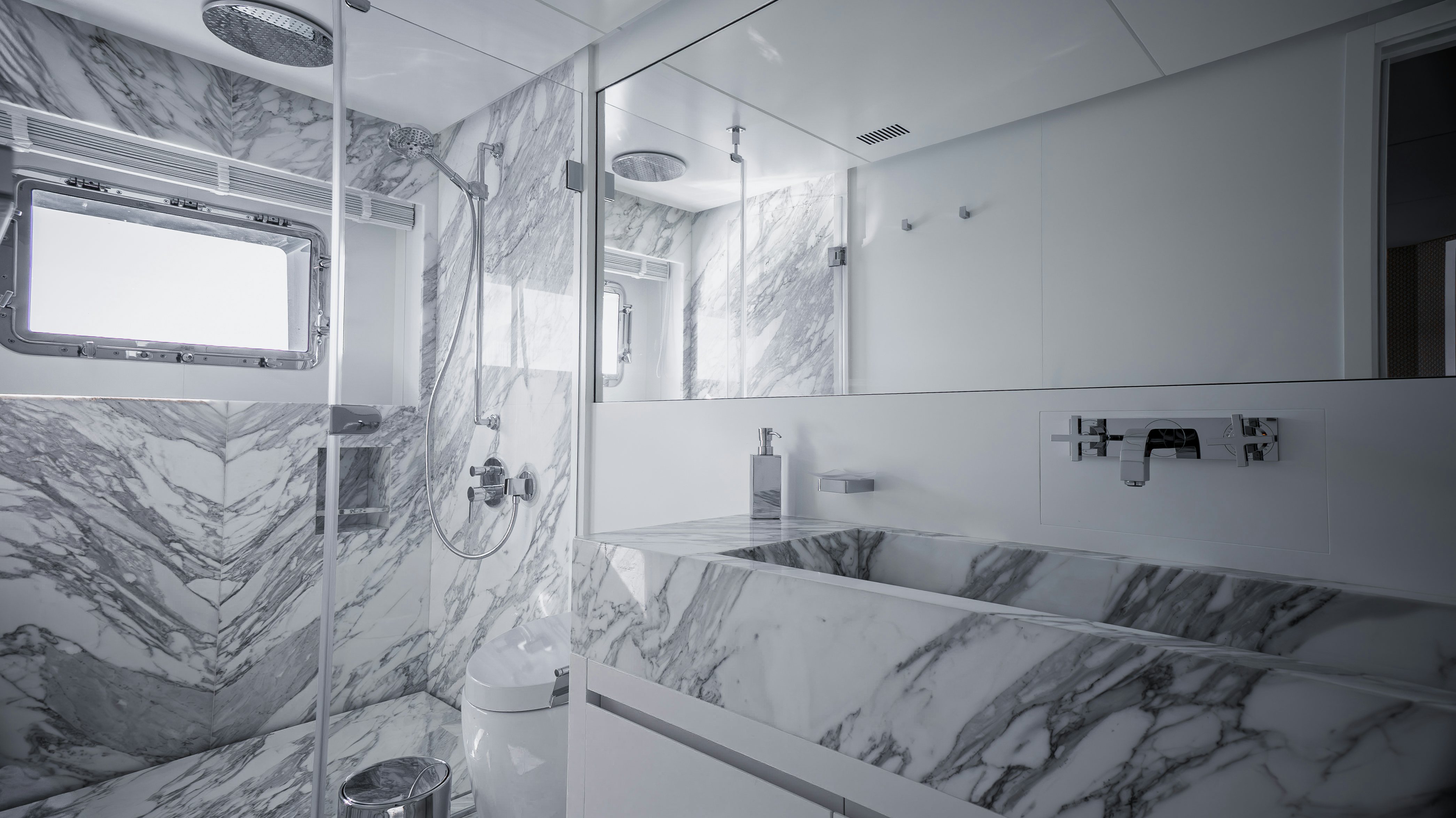 a room with a bed and a mirror aboard RAY Yacht for Sale