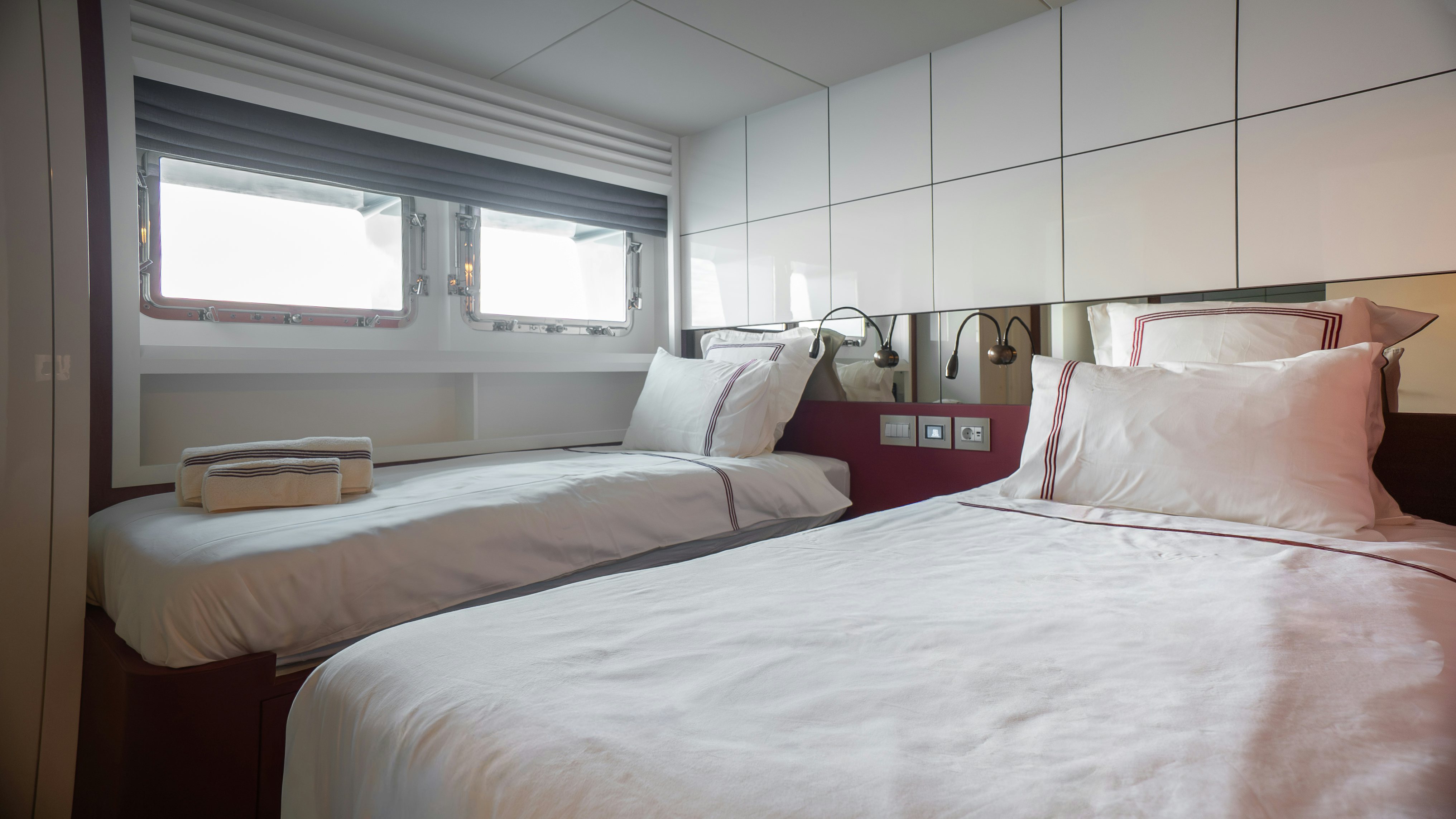 a couple of beds in a room aboard RAY Yacht for Sale