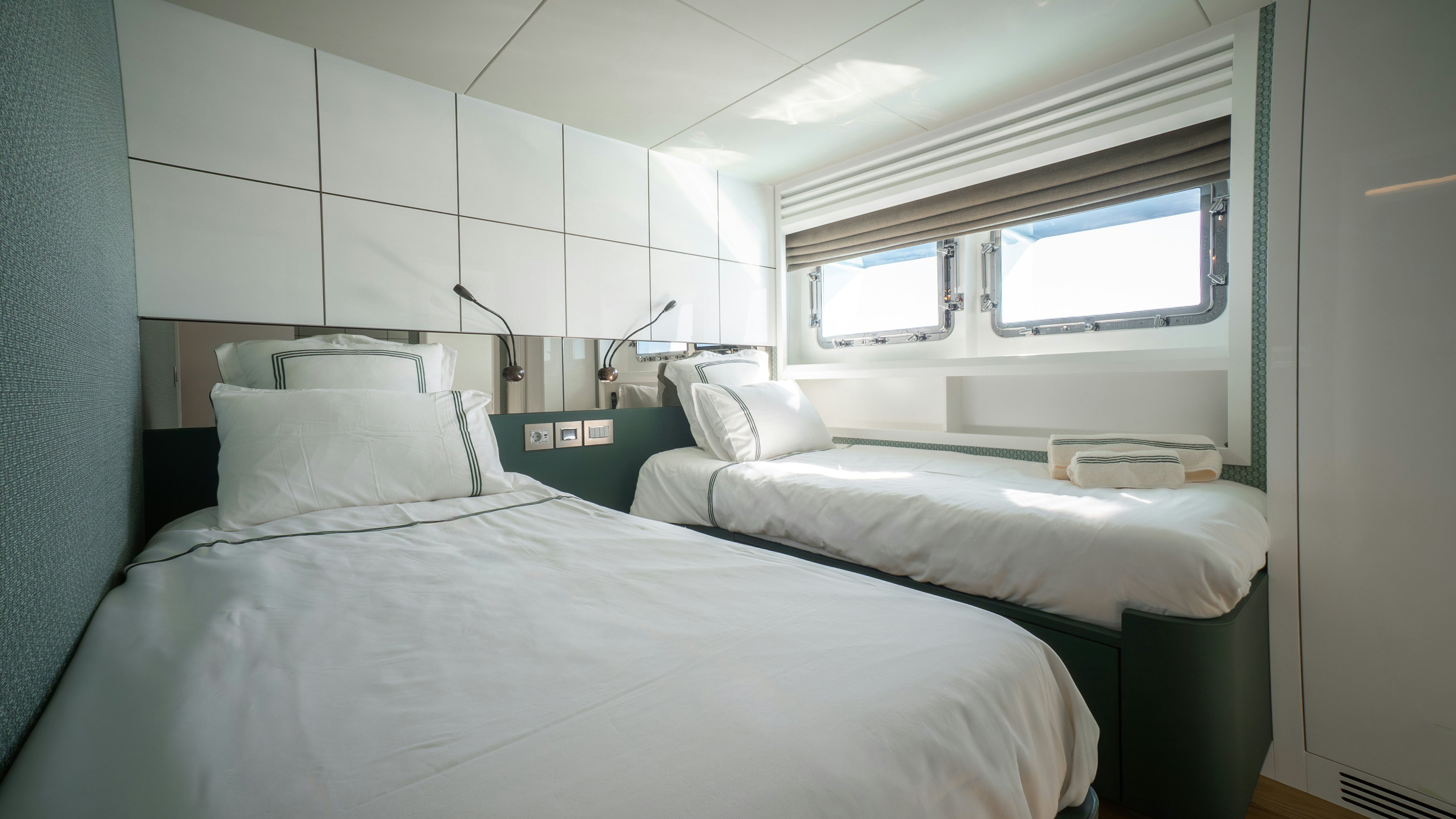 a couple of beds in a room aboard RAY Yacht for Sale