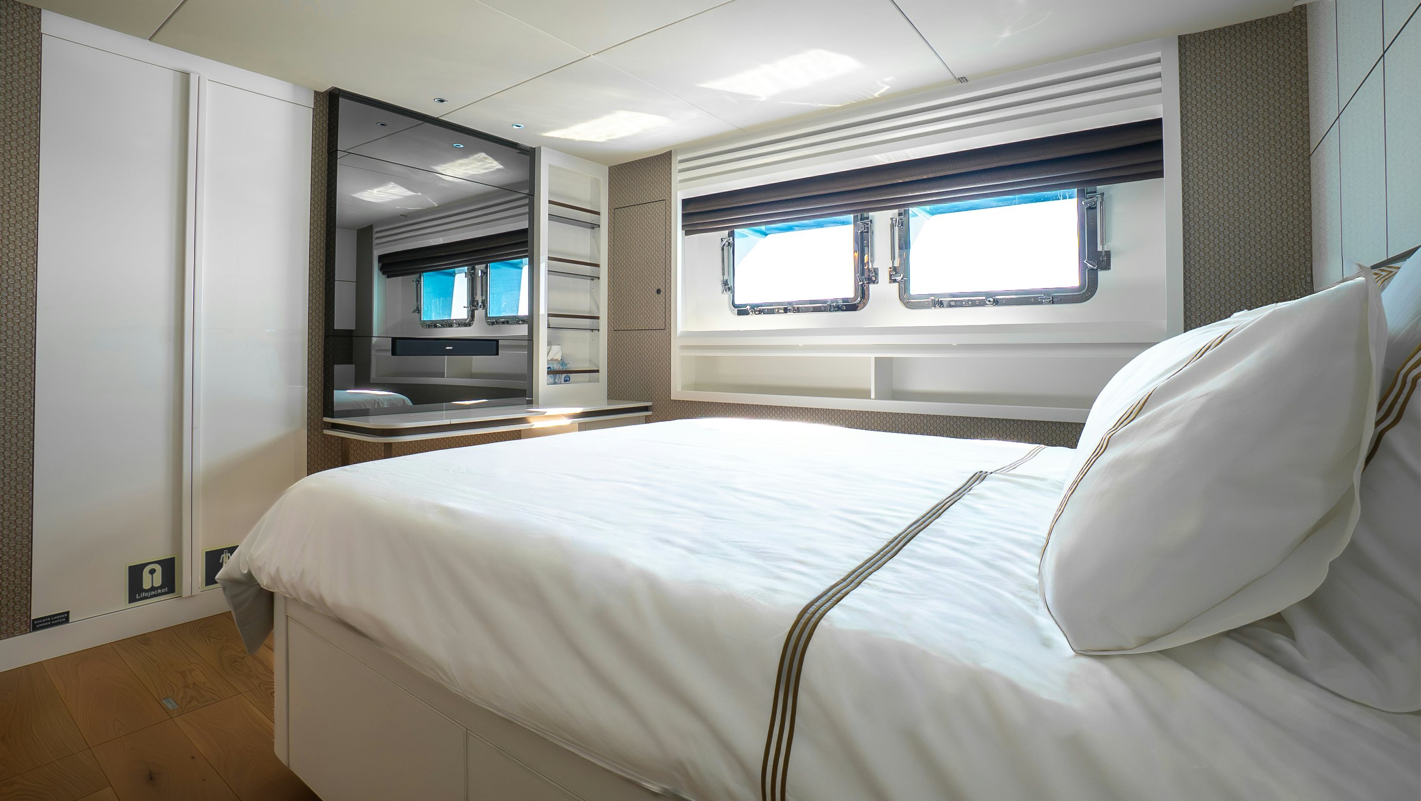 a bed with a white sheet aboard RAY Yacht for Sale