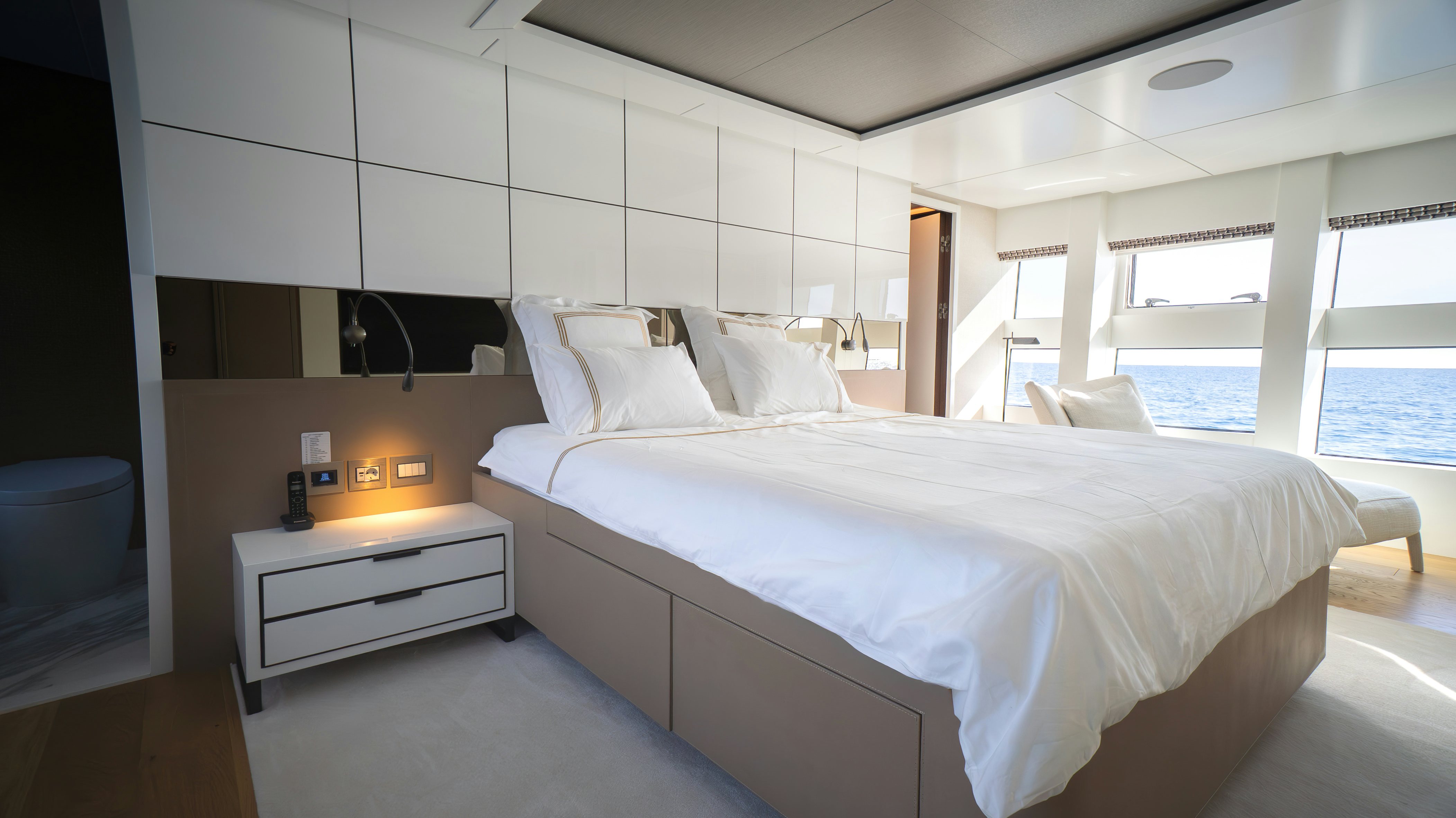 a room with a bed and a table aboard RAY Yacht for Sale