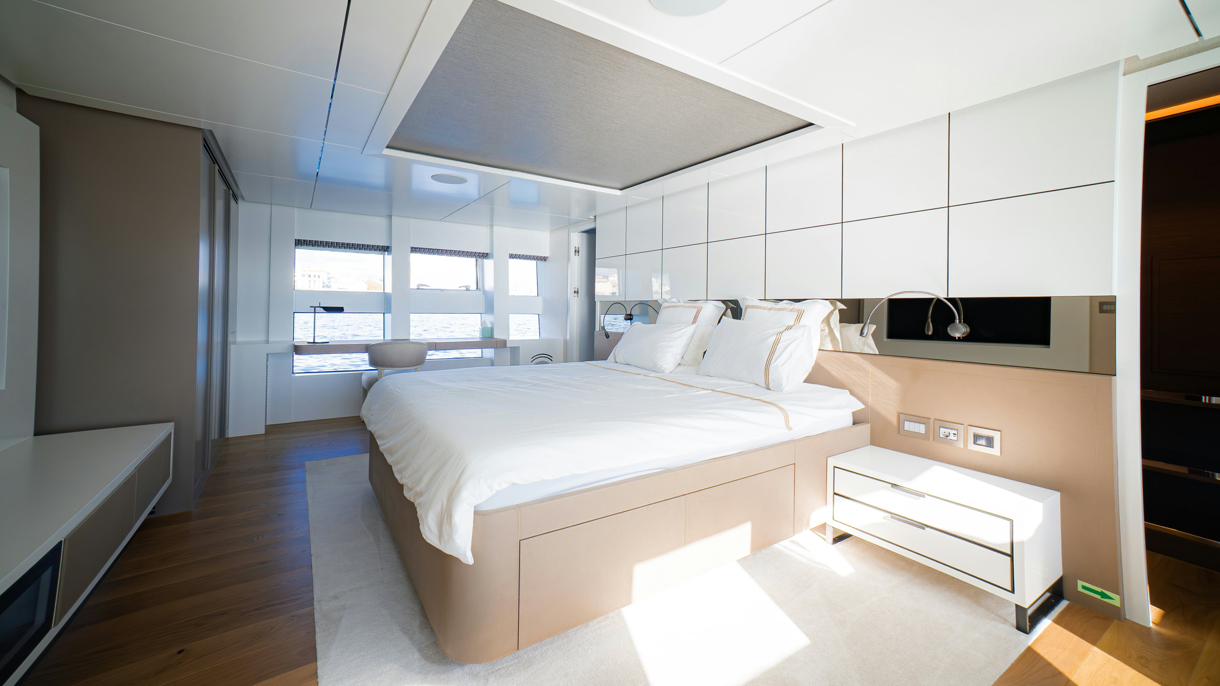 a room with a bed and a desk aboard RAY Yacht for Sale
