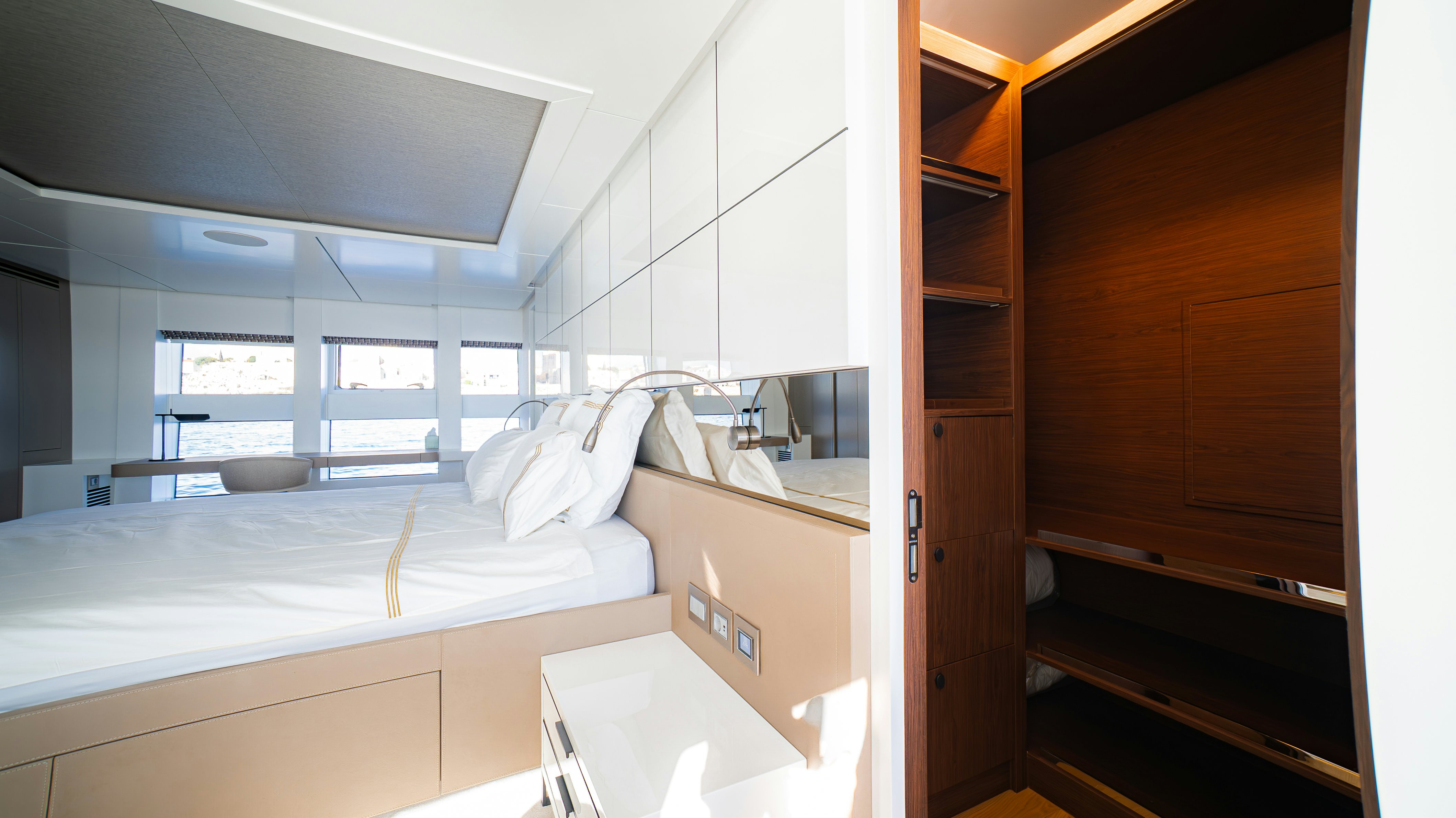 a room with a bed and a desk aboard RAY Yacht for Sale