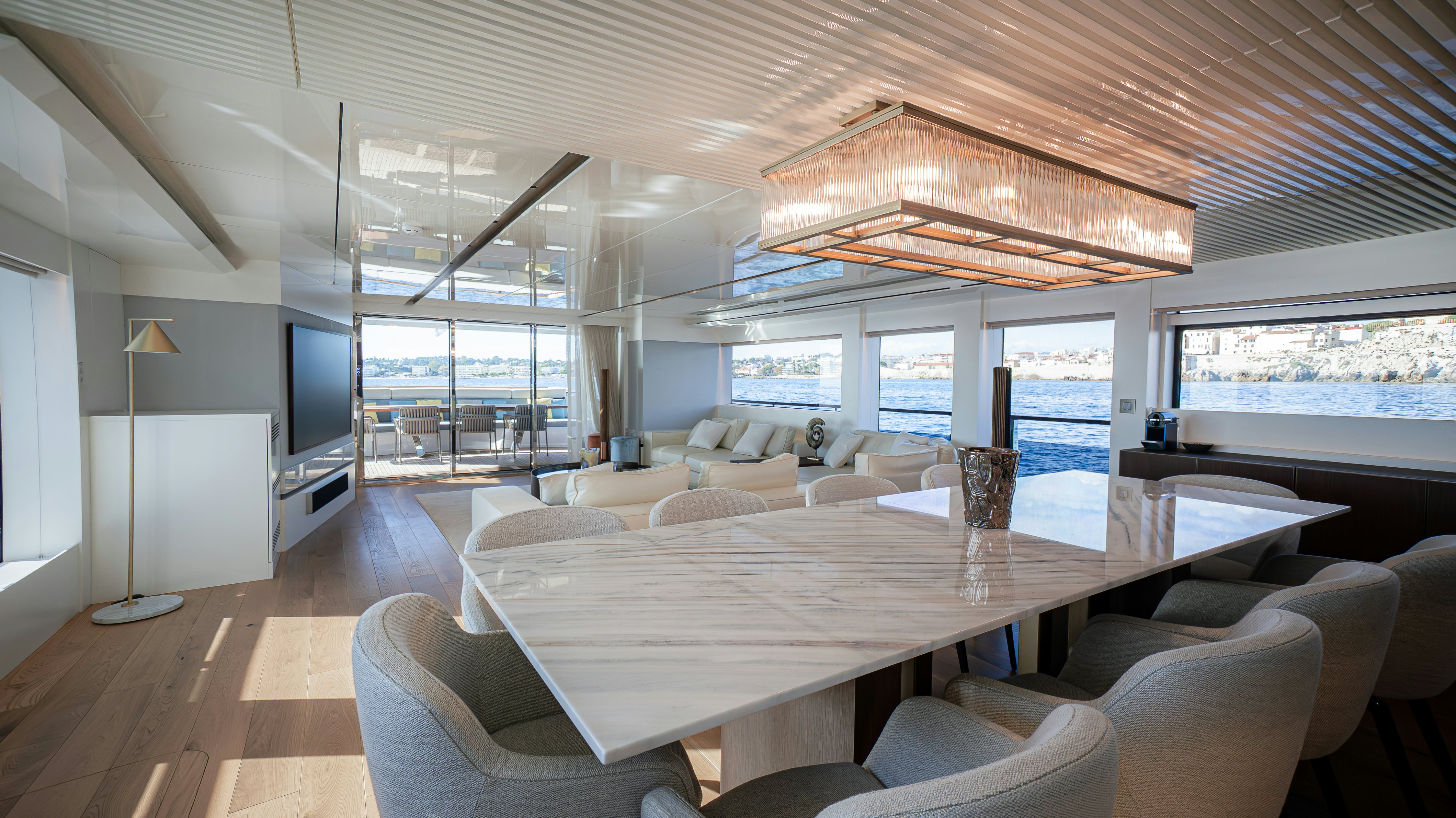 a large living room with a large table and chairs aboard RAY Yacht for Sale